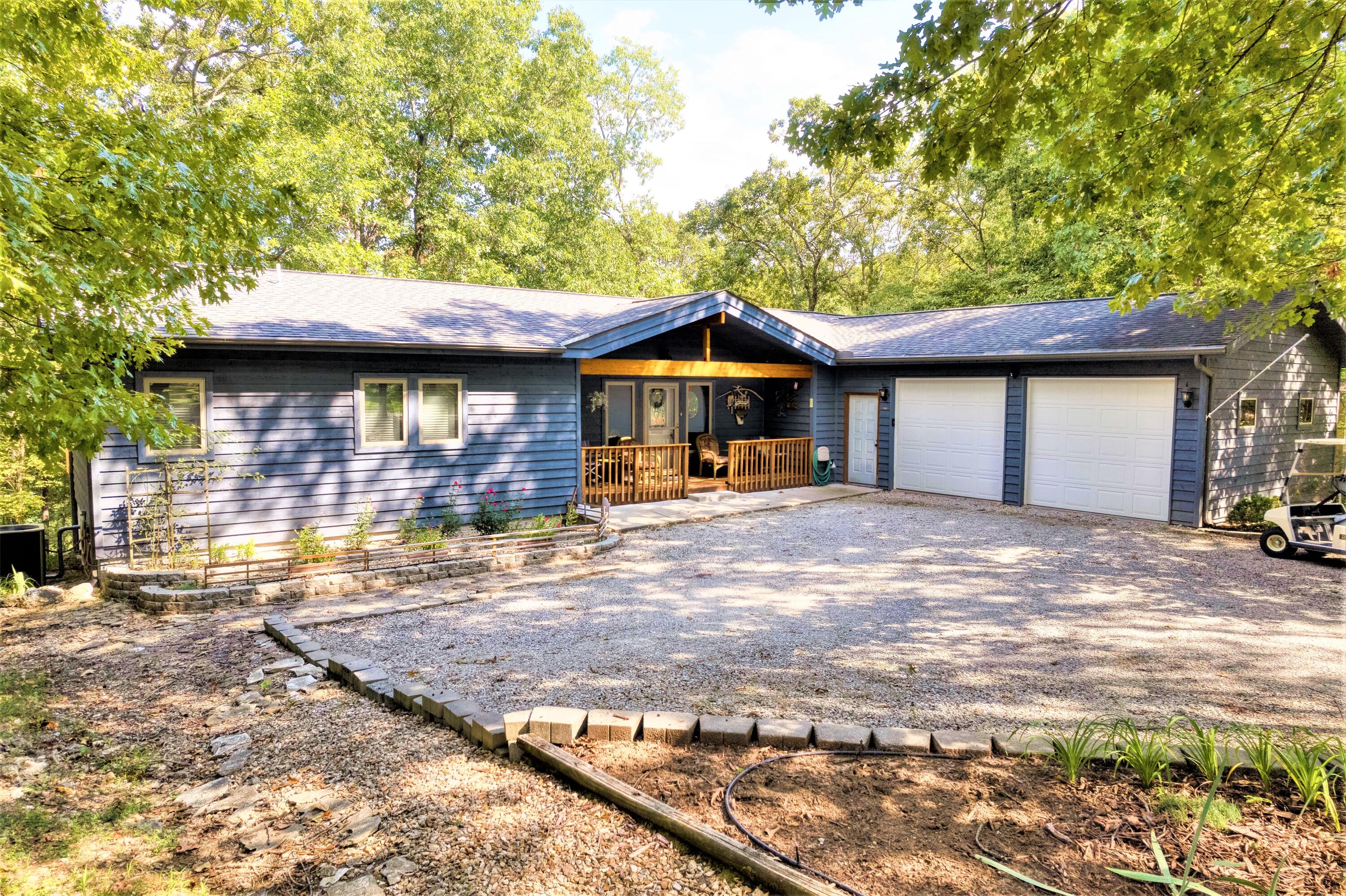 Wonderful 4 bedroom 2 1/2 bath one-owner lakefront home close to Shell Knob.  Price includes a  10 x 20 slip with lift within walking distance of the home.  Home is a Lindal cedar home and features vaulted ceilings throughout.  Beautiful cedar beams and ceiling in the living room.   The main floor features the master bedroom and office with 3 additional bedrooms and family room downstairs.  The wooded lakefront lot is over 1/2 acre with a full deck along the back of the home.  Screened in porch  off the kitchen dining area with access to the deck.  Golf cart included with an acceptable offer.  Some home furnishings are negotiable.  Come take a look at this one, very unique property with an amazing setting!