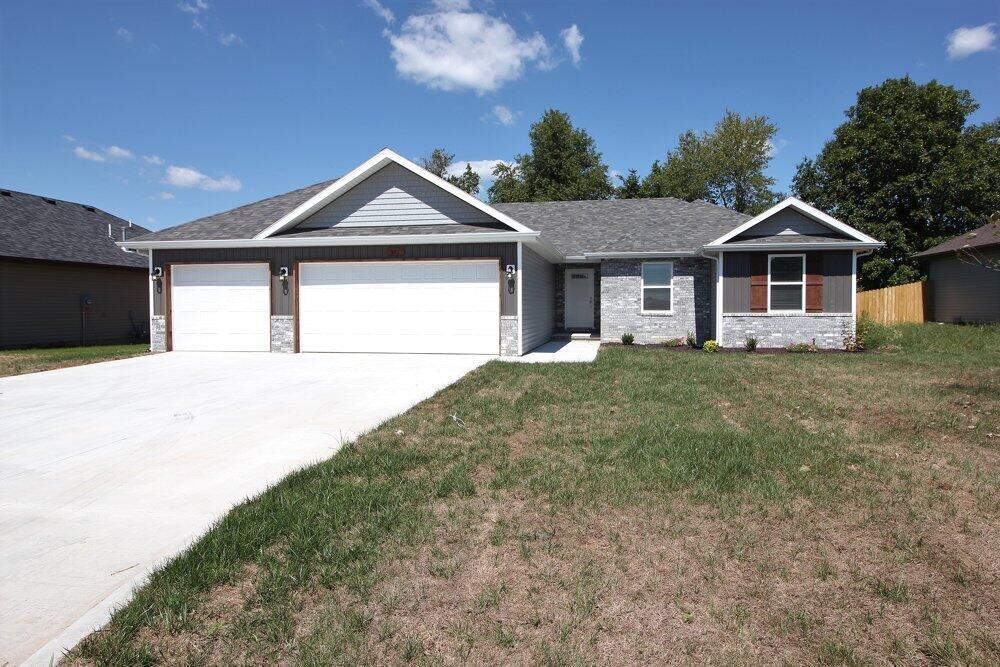 NEW Construction home located in Woodland Hills Subdivision in Rogersville. This home features a split 4 bedroom, 2 bath open floor plan with a 3-car garage. Luxury vinyl plank flooring throughout the home. You will love the garage entry with a walk-in pantry, drop zone bench and large laundry room. Kitchen features custom wood cabinets with stainless appliances (including refrigerator), island seating & dining area. Large master suite has walk-in closet, dual-sink vanity and walk-in shower. Granite counter tops are found throughout the home! The front yard is sodded. Maintenance-free exterior and back patio overlooking a fully-fenced private backyard. This new home is ready for you to make it your own!