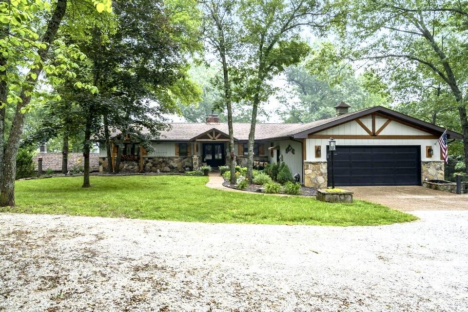 Spectacular Table Rock Lake views wrap this beautifully renovated home from every angle. Located on a large 2.9 acre lot 1300 ft above sea level atop one of the lakes highest hills (1322 ft), this spacious, open concept includes 4 bedrooms, 4 full bathrooms, large open kitchen with updated lighting fixtures, walk in pantry, newly updated laundry room with brick flooring, stone fireplace, large master bedroom with his/hers walk in closets and roomy ensuite bath with gorgeous soak tub and walk-in shower. Fresh landscaping including exterior lighting, recently stained deck, hard wired propane lines for grilling and updated sunroom make it perfect for dining by the beauty of the water. Lower level is an ideal separate living space with kitchenette, 3 bedrooms, 2 full bathrooms, a second stone fireplace and living area with new barn door sliders. Needing a respectable shop? We have it in spades! 588 sq ft of highly functional heated shop with direct access into the house and separate John Deere room. Large gatherings? No problem in this sprawling beauty situated at the end of a secluded private road with circle driveway. (Full list of updates attached.) Boat slip and lift just a golf cart ride away are available for extra $$. Enjoy the fireworks from the Chateau right from your back deck! Conveniently located close to Kimberling City and Branson West. This lovely, secluded lake home is a rare opportunity!