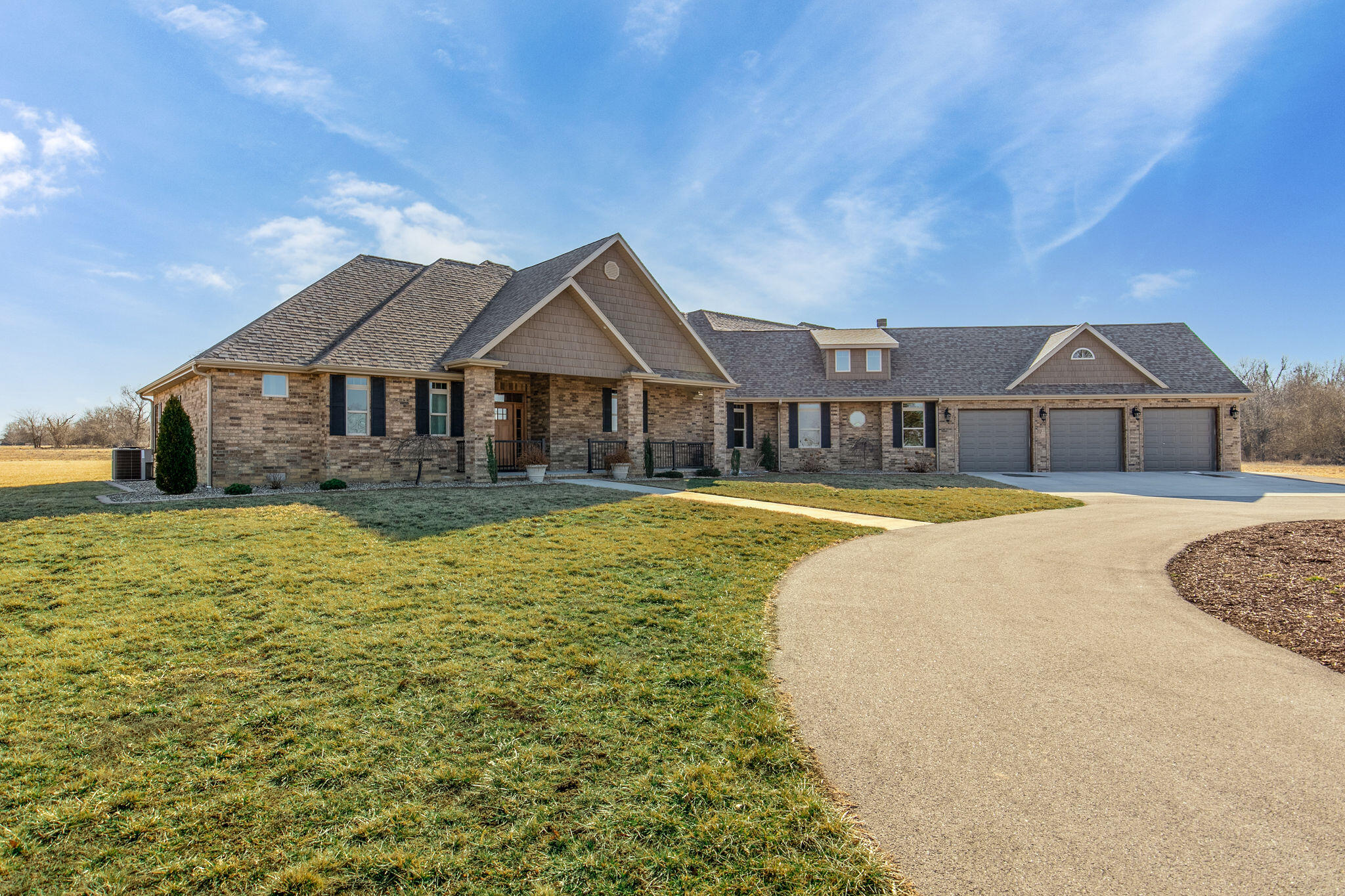 WELCOME TO THIS CUSTOM OASIS!!!!!!!!!!!! Sitting on 14+/- acres, this one level all brick one- of- a- kind home was designed to be a peaceful retreat. Upon entering the home step into the open main living room, dining and kitchen combination where you will be greeted by tons of natural light and an oversized, stone, gas fireplace, perfect for cozying up with your morning coffee. The kitchen features an abundance of cabinets, a large island, built-in buffet, gas stove, and a double oven making this kitchen any cook's dream come true! The leather finished granite ads to the elegance of the kitchen. As you open the large walk-in pantry door the light automatically turns on for you AND the interior door has a built-in spice rack!! To the left of the main living area the perfect bedroom layout is found! The LARGE master suite boasts a tiled walk-in shower, and a RAIN showerhead!! BONUS - there is a vanity drawer set up for hair appliances to stay PLUGGED IN!! To the right of the open living area you will find an oversized office space, down the hall on the left are two bedrooms that share a Jack-n-Jill bathroom with a vanity in each bedroom for a convenient morning routine. Plus a half bath across the hall! The family room, with a WOOD BURNING FIREPLACE, is the perfect space to play games, entertain, and make memories!! The guest quarters that can double as a mother-in-law suite having it's very own Private ENTRANCE. Perfect for independent living!!!! Featuring 1 bedroom and 1.5 bathrooms, access to the garage, and a private, covered patio. This great space could double as an Airbnb with proper county approval.The backyard, covered patio is the ultimate cookout spot!!! Featuring a 2 burner cook stove, outdoor refrigerator, sink, natural gas BBQ and natural gas fireplace, and wiring for an exterior TV and seating area around a fire pit! - the options are limitless for those late night summer BBQ's. There is also a unique drip system for all flower pots and landscaping in