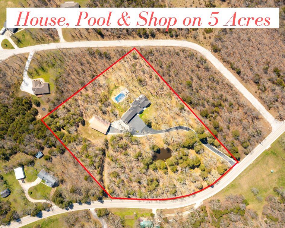 HOUSE, 5 ACRES, POOL, POND, SHOP & PRIVACY! What more could you ask for? This gorgeous ONE-LEVEL home on 5 park-like acres features 3 bedrooms, 3 1/2 baths, 2800 sq. ft., hardwood floors, crown molding, sunny sunroom with wall of windows, cozy living room with new pellet stove, master suite with his & her baths, office, storm shelter,  encapsulated crawl space & more!  Huge 64 x 36 shop (man cave) with overhang, office, two 9 x 9'6 doors. The back yard is an entertainer's dream! Enjoy the pool or lounge on the deck and watch the wildlife! The pond is stocked with grass carp, bass & blue gill! This property is a dream come true! Close to town but with the feeling of being in the country, this is a must - see!
