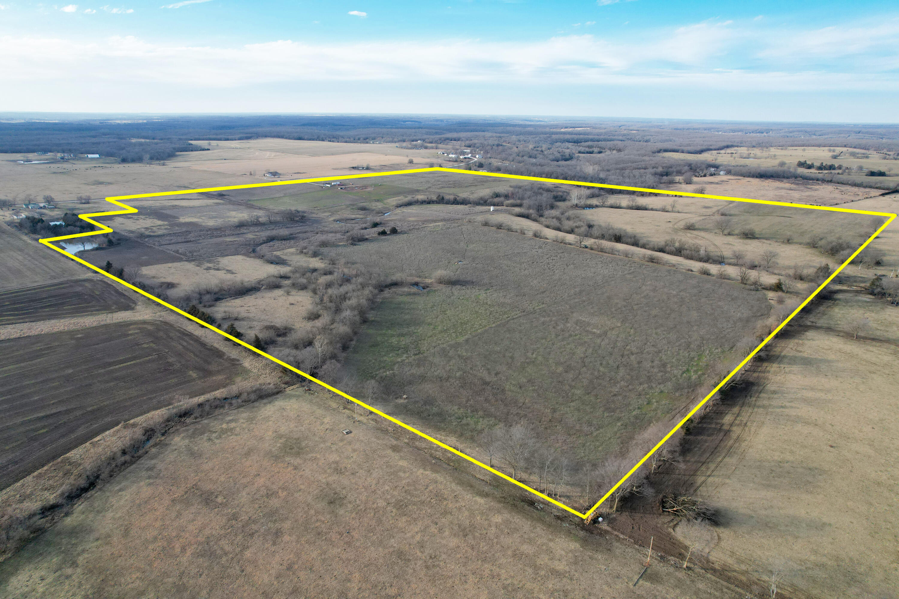 Discover a prime investment opportunity in Weaubleau, Missouri! This 144 +/- acre property is strategically located off State Highway MM just minutes from 54 Highway. This is a rare find with a mix of hay and row crop ground that is also completely fenced with some cross fencing for cattle. Along with live water and the pond for livestock, there is also a 650' deep well.This property not only excels in its agricultural potential but also presents so many possibilities for a building site. Picture waking up to the sunrise over your 144 +/- acres, or watching all the wildlife as the sunsets. To delve deeper into the possibilities that await schedule a private tour of this exceptional property.