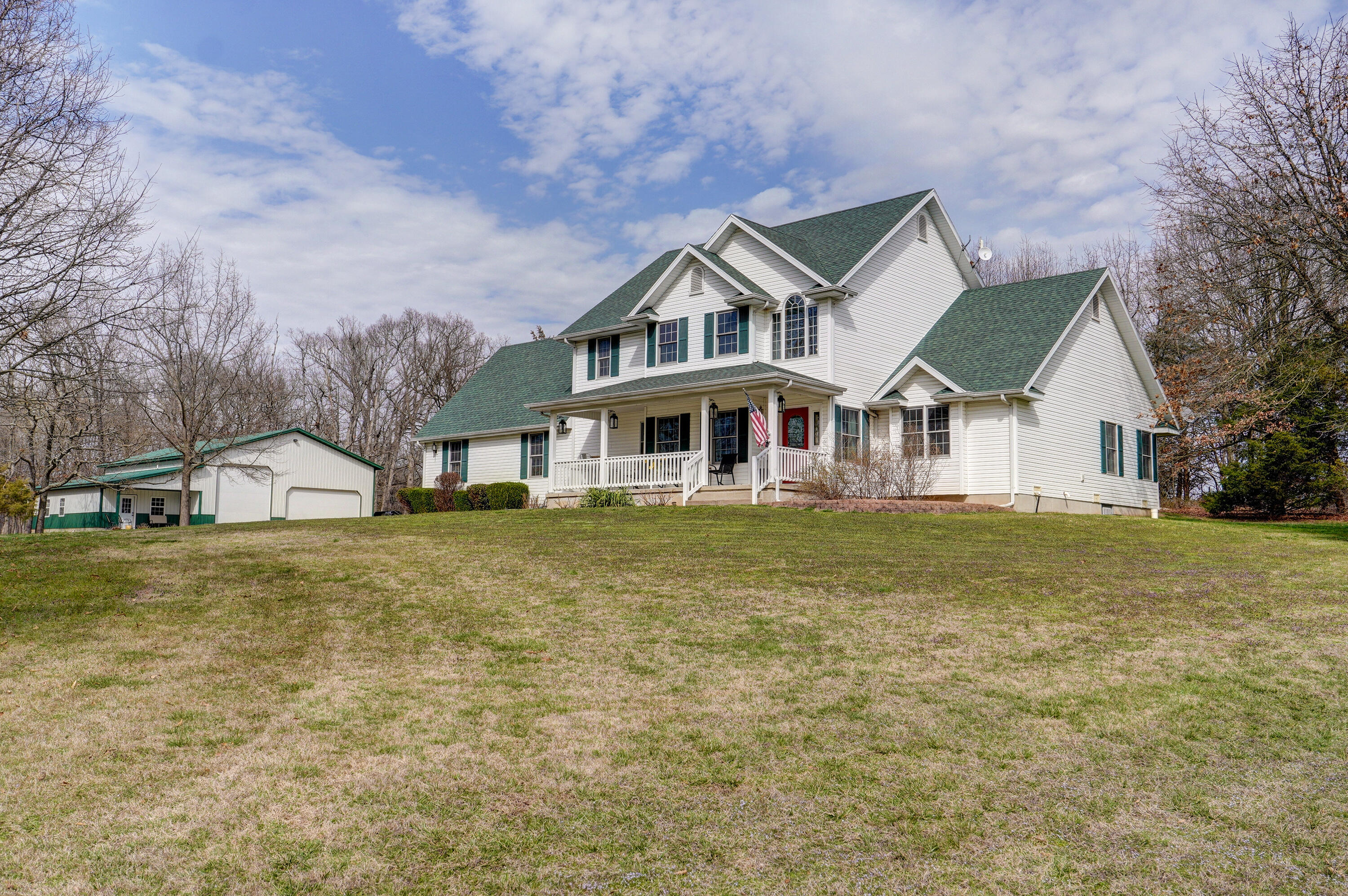 A RARE FIND! AMAZING LOCATION WITH PRIVACY & AMAZING VIEWS! ONLY 5 MINUTES TO REPUBLIC! Beautiful 1.5 Story Home on 20 picturesque acres. Great for horses, cattle, hobby farm or a nature lover. This home features approximately 2560 sq ft, with 4 BRs & 2.5 Baths. 40x50 shop w/ attached 16x42 finished studio & a 40x40 3-stall horse barn. This spacious home boasts 17 ft ceilings from the entry way through the living room with a 17 ft. stone fireplace as the focal point. Large master suite on main floor. Kitchen has a walk-in pantry, large breakfast nook & center island. Formal dining, 3 bedrooms upstairs with a full bath. The 4th bedroom is the bonus room upstairs. It is large enough for an additional family room, craft room, & is the non-conforming 4th bedroom. Attached oversized 2 car garage. Across the paved driveway is a 40x50 shop with full RV hookup, wood-burning stove, and lots of space for your 45 ft RV & other vehicles. Attached to the shop is a 14x42 finished studio w/ central heat & air. Studio includes 1/2 bath & large storage area. This could be used for a home business, home-schooling room, company, or in-law quarters. 40x40 3-stall horse barn with loft storage. 5 acres is fenced for grazing, with more land that could be fenced. This home is in a neighborhood w/only 8 other homes. All homes are on 5 or more acres. It sits on the largest lot, at the end of a dead-end road & also has a .10 mi. driveway, w/lots of trees, giving you privacy. The 20 acres includes over 1/2 mile of wide, manicured trails for walking or riding through meadows & woods. Enjoy birds, deer & sunsets.  Great for bow hunting & 4 wheelers! Large raised-bed garden, fertilized & ready for planting. Plenty of room for your chickens. This home has fabulous curb appeal w/unlimited outdoor entertaining possibilities. Enjoy sunsets & great views from all three patios. Location is unbeatable, only 5 minutes to Republic & 20 minutes to Springfield. Don't miss out on this amazing property