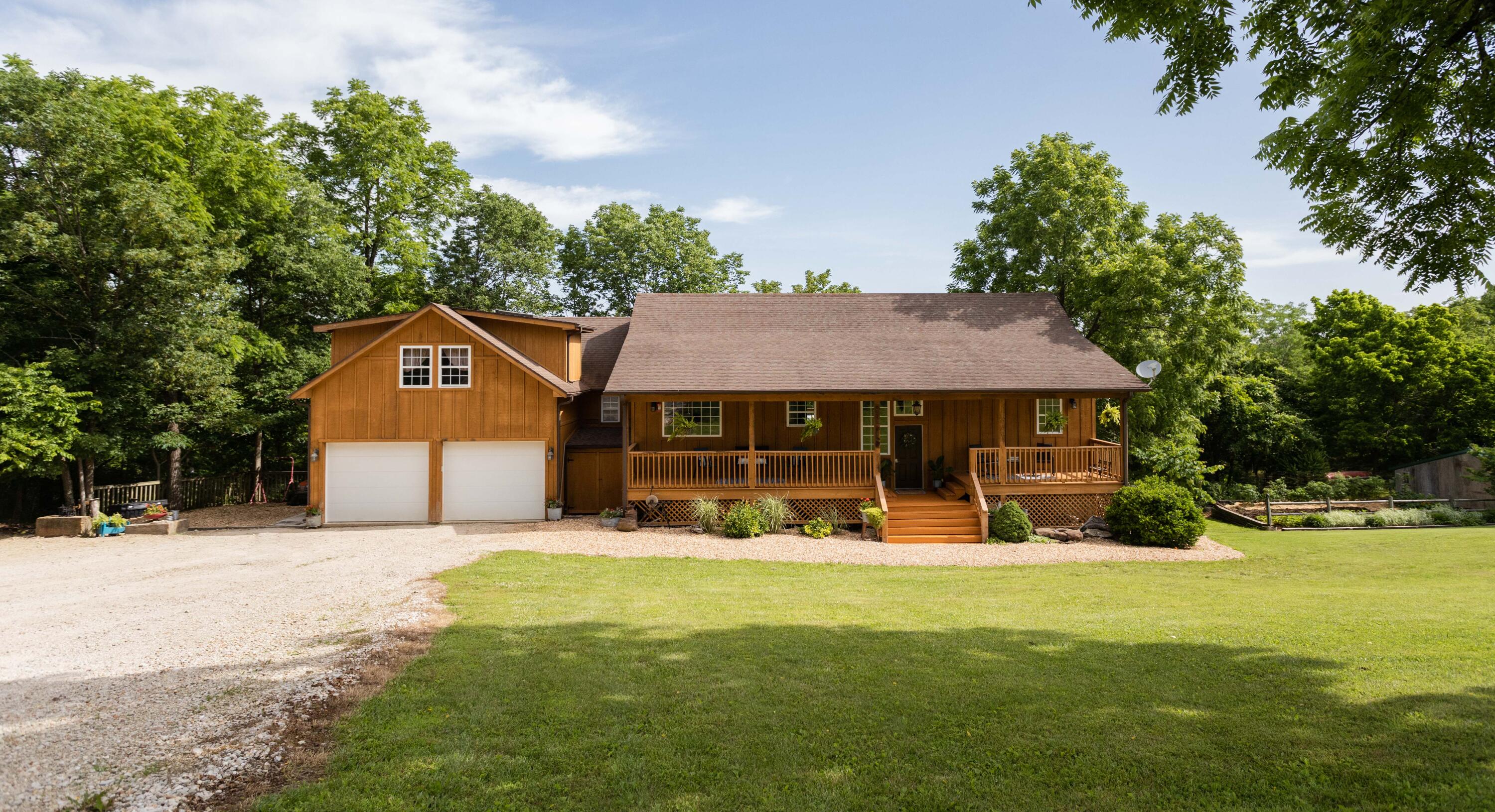 Welcome to Victor Chruch Road. Sitting on almost 8 acres, this country beauty has something for the entire family. You are sure to enjoy the peaceful starry nights outside sitting by the fire pit that is surrounded with gorgeous rock work. For the hobby farmer, there's a large garden with chicken coop to help keep the grocery bills low. Behind the garden is where you'll find hunting opportunities with cleared grounds for a small food plot. On your way into the home, you'll notice a gorgeous front porch overlooking a beautiful yard. Enjoy your morning coffee while watching your children on a tire swing hanging from a large walnut tree. On the inside, you'll see just how much this 4,000 square foot home has to offer. It features five bedrooms, four bathrooms and a large office or possible sixth bedroom to serve as an in-law suite above the garage. When you walk downstairs, right away you'll notice the large windows and ceilings which make it feel completely open and not like a typical enclosed basement. There's a huge open living area with a nice kitchenette. It could serve perfect for a kid's game room, family movie room or a second in-law suite. With this home you can enjoy all those large family gatherings you've talked about hosting and even have some room to spare. Don't miss your opportunity to live in this beautiful country atmosphere with all the convenances close by including Walmart, shopping at bee creek, Branson Rec plex and Branson high school all within 10 minutes. You are all that is missing!