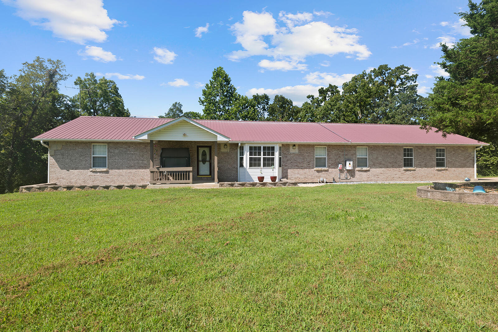 Home on 3 acres in Rural Southern Missouri for sale offering SPACE, LOCATION & MOVE-IN-READY! Just a short distance to town, this home is located in a HIGHLY sought after location with a mixture of open and wooded land with over 4000 Sq Ft!  There is a three car attached garage with plenty of space for storage. The home offers four bedrooms, three full bathrooms, large walk-in closets, 2 huge laundry rooms, kitchen with newer gas stove and all stainless steel appliances. This is an open layout with kitchen, dining and living room area.  There's a large sunroom on the back of the house that leads to a deck that leads to a covered deck. The two washer dryer hook ups are on the main level and the lower level. The lower level with kitchenette area has multiple storage areas, a huge family/living room, office area (could be a non-conforming 5th bedroom) and access to a covered patio area perfect for entertaining. Lower lever could make the perfect second living quarters. This energy efficient home includes solar panels for efficiency. From your deck and patios you will enjoy watching the abundant wildlife of the Ozarks outdoors. Don't miss this opportunity for a quality home with lots of space offering location, location, location. You will not find a property like this with the square footage and VALUE! Call TODAY to view this amazing home!