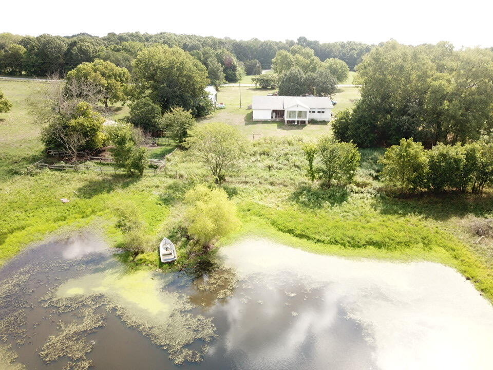 Price just reduced $100,000.  Don't miss out on this great opportunity to own a 197-acre working cattle farm with a 3-bedroom 2 bath home with large, attached garage. This home has a rental income of $700 a month. Everything is in place; it currently runs a 60 cow/calf operation.  2 wells.  Approximately 50 acres hay ground.  Has fairly new cattle pen working facility, with new watering system throughout the farm. It is fenced and cross fenced with lots of it being new. 4 barns, two large ponds, and lots of grass. About 85% open 15% timber.  There is a Fruit tree in the front yard and a small garden area on the side.  These types of setups don't come around very often. Shown by appointment only.