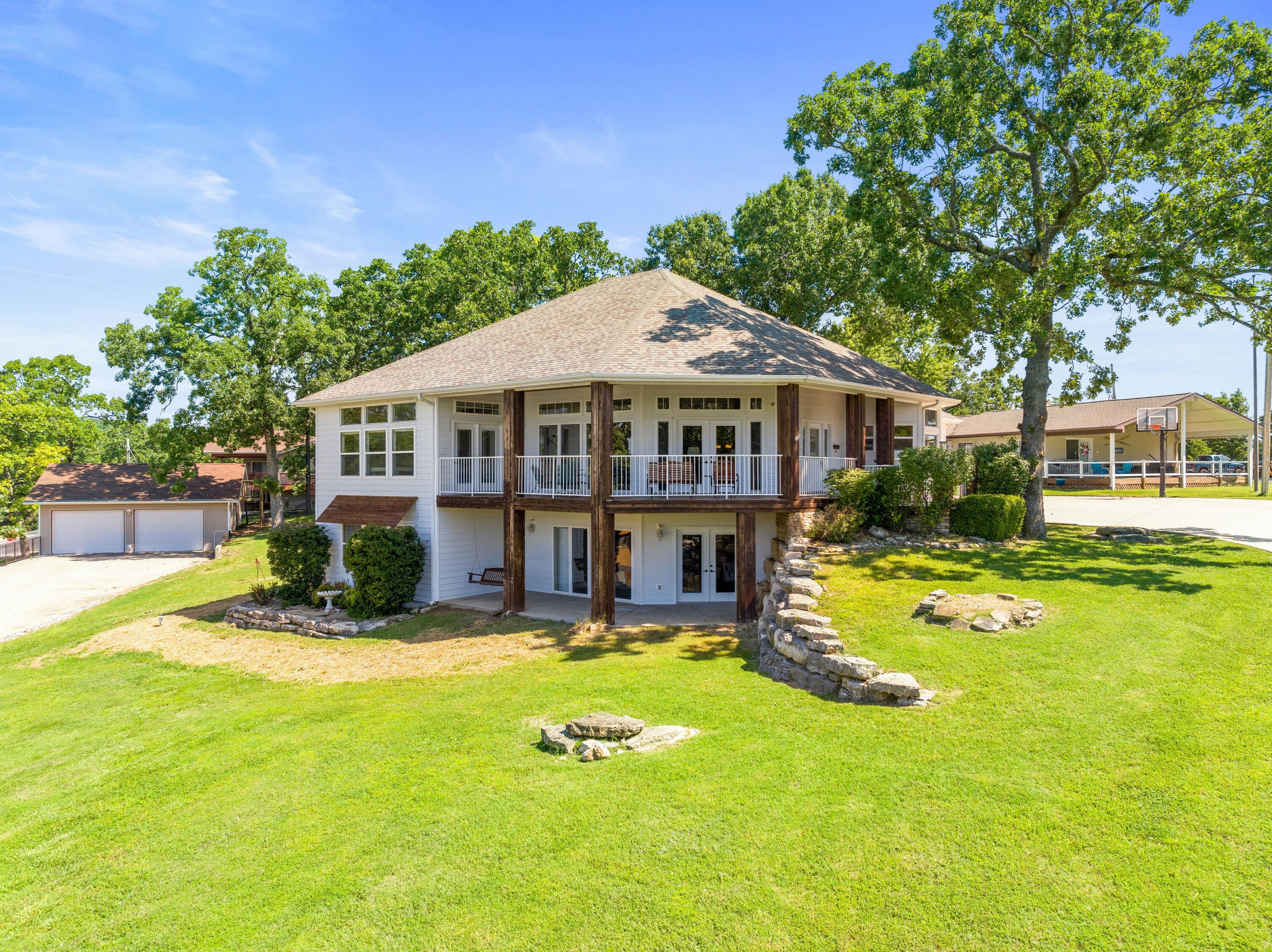 You can have it all !  Year Round Panoramic Lake View,  walk to the water, launch, boat slip option (10x24 w/Lift & Locker plus a Sea Doo port - add $) - all a short walk from home, easy & excellent lake access for swimming, fishing and fun all found at the ''point'' at Hoot Owl Point.  This Pankovits Const home is gorgeous and ready for ultimate lake living.  The rooms are spacious; garage is oversized with plenty of room for all the toys and cars (30x40), a total of 1,200 sq ft and is Heated & Cooled).  Desired Hoot Owl Point subdivision is minutes to Hwy 13, close to Kimberling City and Branson convenient to marinas, shopping, restaurants and medical.  By water this home is about 10 minutes (and about 4 coves) from the Kimberling City Bridge.  Here's the place to be - come see for yourself 123 Chinkapin Ln.