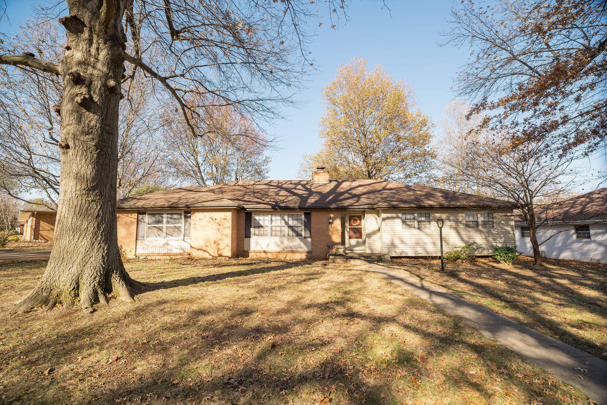 This lovely ranch-style home is a gem tucked away in a quiet neighborhood in southern Springfield while near all the convenient amenities located along south Campbell. Step inside to find an entryway with white stone flooring that transitions to hardwood that sprawls across a spacious livingroom to the left with large windows. Straight ahead of the entryway is the family room with a gas fireplace and open layout overlooking the kitchen separated by a breakfast nook. The kitchen has beautiful solid wood cabinets and plenty of countertop space and storage. A breakfast nook is set below lovely bay windows on the opposite end of the kitchen near the hallway. A formal dining room is conveniently accessible from the main livingroom and connect to the kitchen. The split floor plan offers plenty of privacy for the master suite and bedrooms. The master bedroom is spacious with a private bathroom and a large closet. Two additional bedrooms down the same hall. Off of the formal dining you will find a four season sunroom that can be enjoyed throughout the year. When you walk out into the backyard you are surrounded by mature trees and a partial privacy fence that allows separation from the neighbors. Don't miss out on a home that has plenty of room to make it your own. Property is vacant and able to be shown anytime.