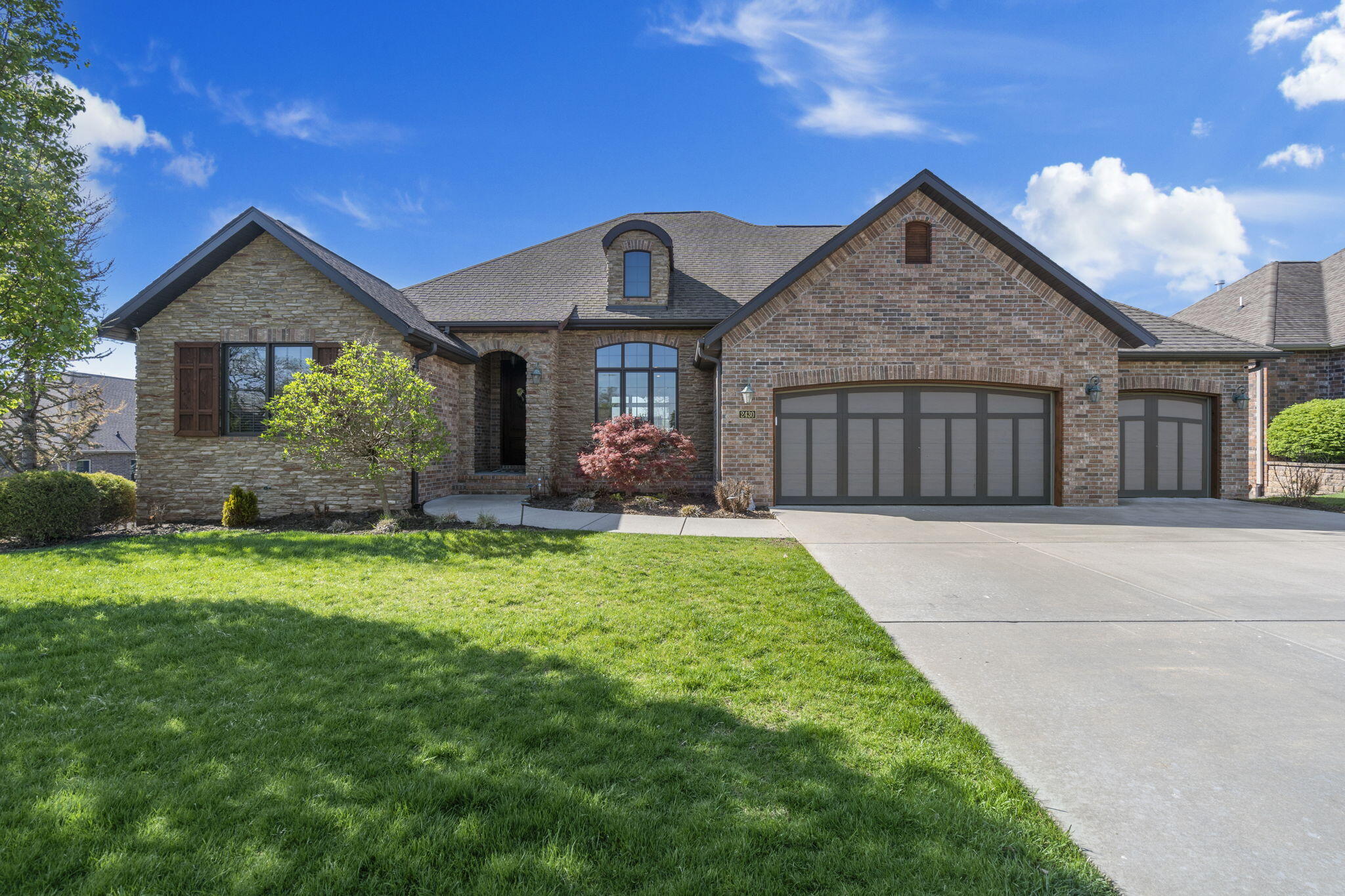 Built in 2014 this one owner home is ready for her listing debut. With 5 bedrooms and 4 full bathrooms across 4,013 square feet this beautiful home has so much to offer and is conveniently located across the street from the neighborhood pool. The main floor showcases an open floor plan with living room, formal dining room and eat in kitchen. The split floor plan offers 3 bedrooms and 3 full bathrooms on the main floor. The master bedroom has a fantastic ensuite bathroom with dual vanities, walk in shower, private water closet and spacious walk-in closet. The additional main floor bedrooms also feature full bathrooms right outside each bedroom door. The kitchen provides plenty of space with granite counters, stainless appliances, large island and walk-in pantry. Right off the kitchen you can enjoy an eat-in dining space and a covered back deck for dining al fresco. Downstairs you're greeted with lots of natural light and a spacious family room it's hard to believe you're in a basement. With walkout access to the back patio inside there is plenty of space for entertaining with a large wet bar and room for ample seating and gaming tables. There are 2 additional bedrooms and one full bathroom downstairs. The basement also includes unfinished storage space, storm room and a John Deere room that was converted to a theater room. With convenient access to all that SE Springfield has to offer this home is one you don't want to miss.