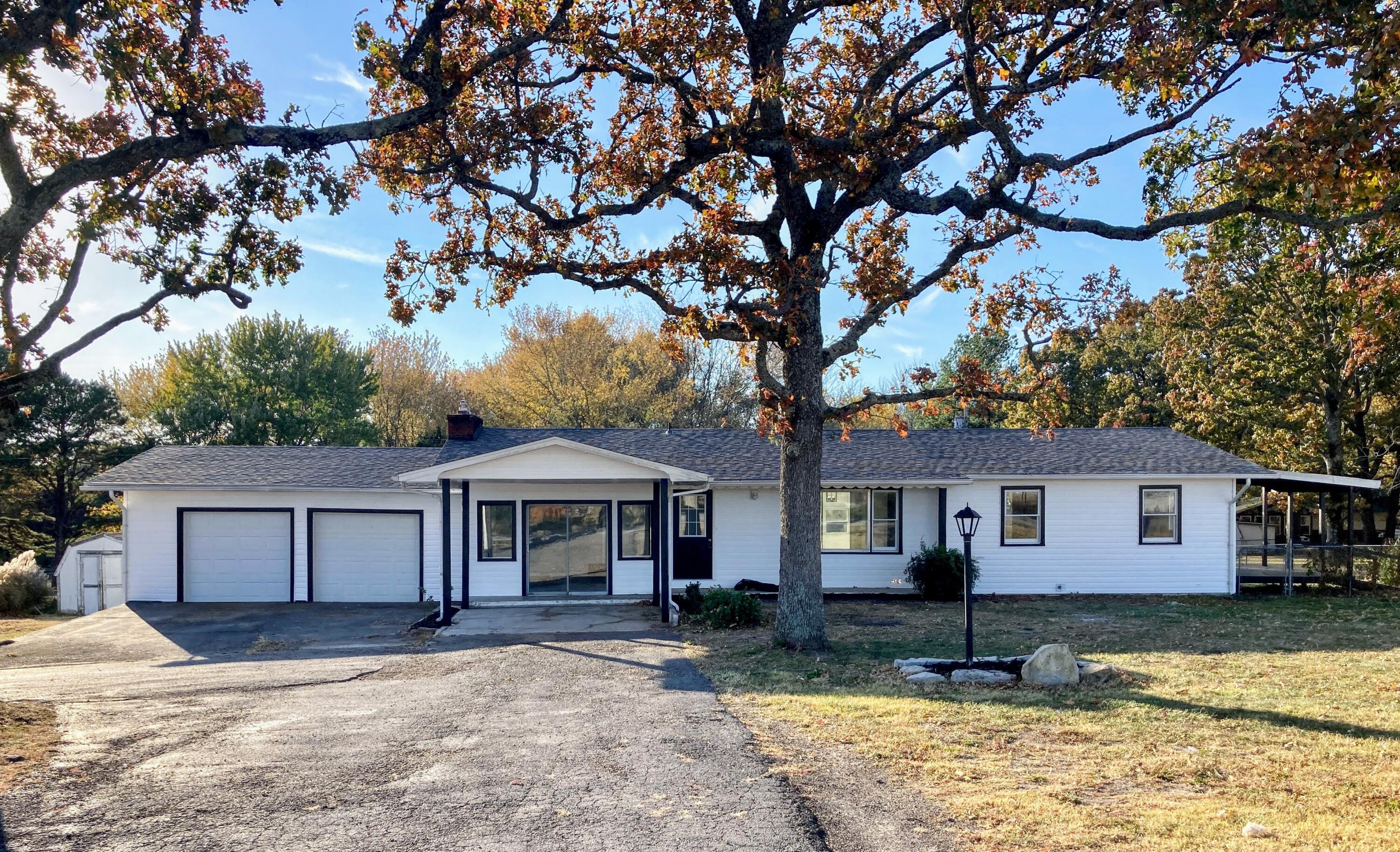 Check out this updated home with a large yard right on the edge of town!   Updates throughout the home include LVP flooring, fresh paint, doors, baseboard trim, stylish light fixtures, and a brand-new furnace.  The kitchen features brand-new cabinets, counters, fixtures, and stainless steel appliances! There are plenty of places to relax as the home includes a cozy second living area with a fireplace, a sunroom off the back, a front patio, and a covered deck off of the side bedroom to enjoy.  The outside features new vinyl siding, a recently replaced roof, a 3/4 acre yard with a chain link fence, and two storage buildings.   This home checks off so many boxes!  Schedule your showing today!