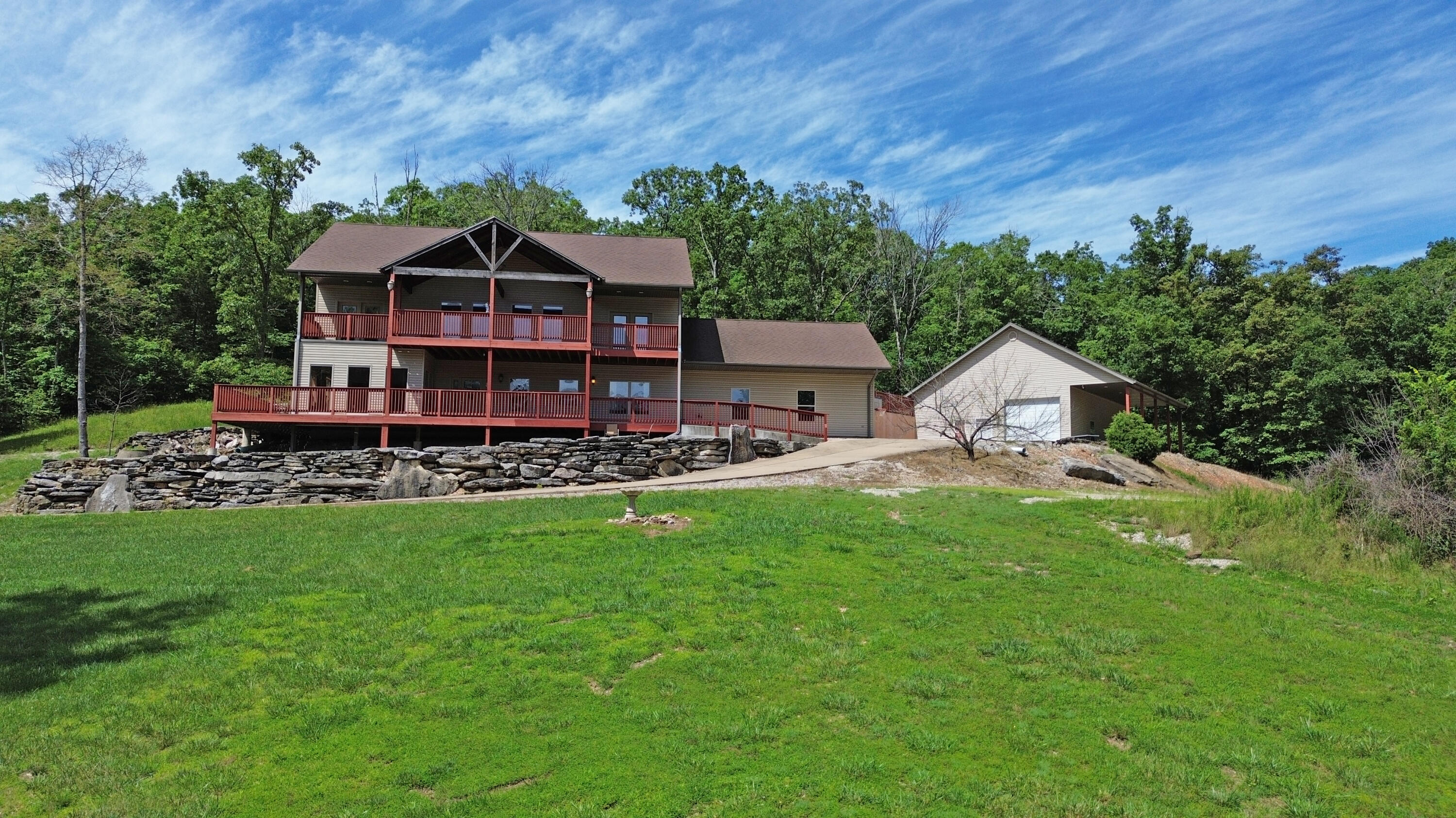Discover Your Own Private ParadiseNestled on 58 breathtaking acres in a secluded valley adjacent to Emory Creek, this extraordinary property offers a rare blend of privacy, natural beauty, and versatility. Whether you're exploring scenic trails, unwinding by the fire pit, listening to the soothing creek, or discovering a hidden waterfall and abundant wildlife, this retreat is a dream come true for outdoor enthusiasts.As you journey down the 4/10-mile private concrete driveway, anticipation builds, revealing a home that embodies both elegance and tranquility. Spanning 3,150 square feet, this stunning residence features an open floor plan, 3 bedrooms, 4 bathrooms, an office/study, and a spacious 2-car garage. High vaulted ceilings and an expansive kitchen--complete with rich alder wood cabinets and pantry--enhance its inviting charm.Step outside to a large, covered deck and wraparound porch, perfect for peaceful mornings or sunset dinners with a view. Two luxurious primary suites offer walk-in showers, private verandas, and oversized closets, ensuring both comfort and privacy. Additional features include porcelain flooring, a patio wired for a hot tub, a video security system, and generous storage throughout.Beyond the home, the 30x40 shop building with a concrete floor includes a built-out bathroom with a shower, making it ideal for hobbies, storage, or a workspace.An Incredible Family Compound OpportunityWith three separate transformers and utilities already in place, this property offers the rare ability to develop a multi-home family compound. Whether you're looking to create a private retreat for extended family or design multiple residences for investment or future development, the infrastructure is already in place to make it happen.With high-end finishes and the option to negotiate furnishings, this is truly a one-of-a-kind opportunity. Come experience the serenity of your own hidden valley.