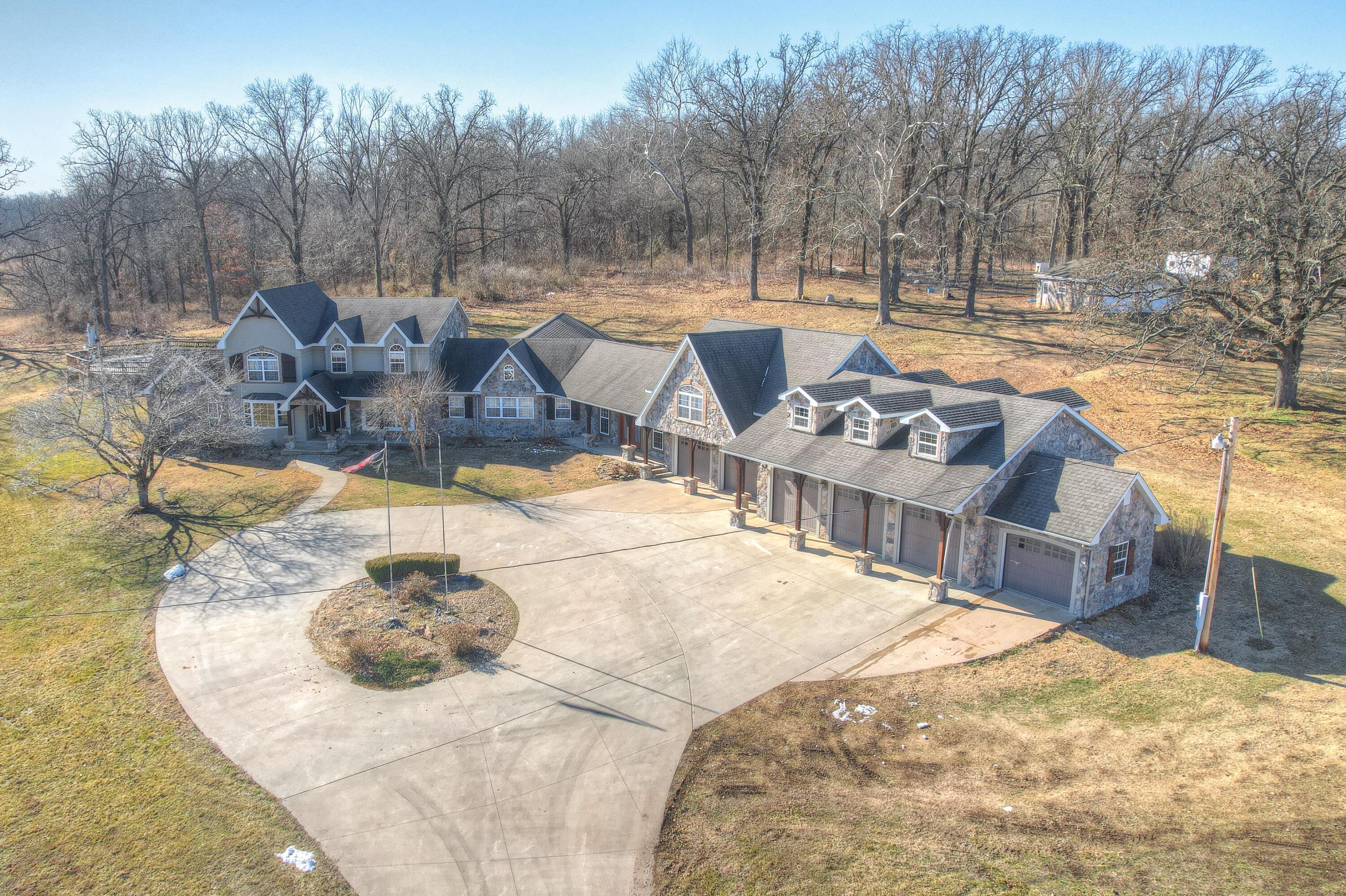 Beautiful one of a kind property. 7 bedrooms, 5 bathrooms, all on 11.76 acres on the corner. 6 garages attached to the house and a 2 car detached garage. Large kitchen with loads of cabinets, all kitchen appliances stay, lovely bar in family room, cozy fireplace in living room, nice size bedrooms, theater. Full apartment over attached garages, tons of storage, outdoor kitchen, above ground pool. 60x40 shop with five 12 foot doors, great storage in loft above shop (use for storage or build an apartment, options are endless), hydrant near shop, fruit trees. Motivated sellers, says to bring offers.