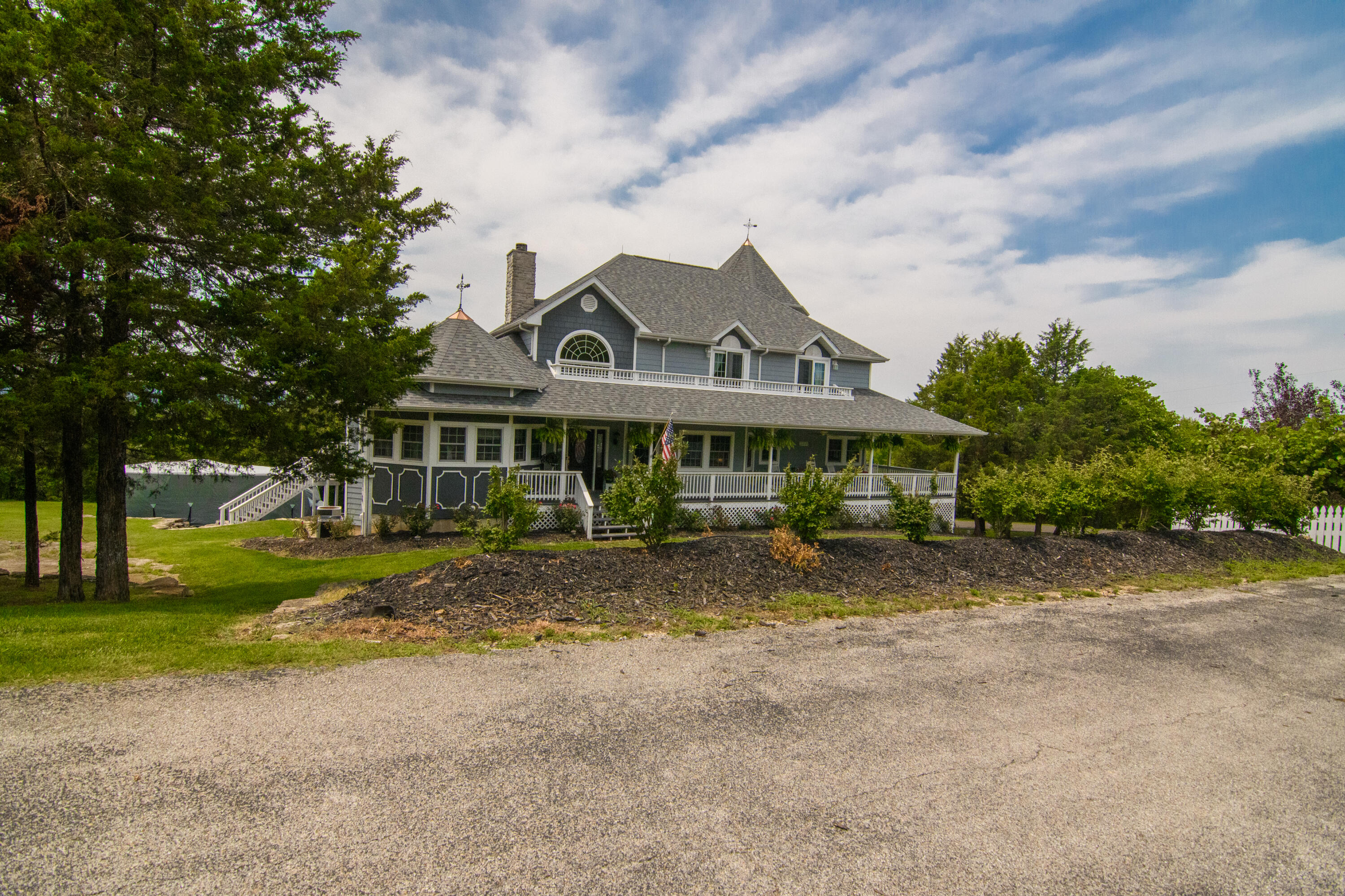 This gorgeous home on 2.93 acres offers upscale country living less than 10 minutes from the Branson Landing. Features such as a chef's kitchen, large pantry with a dumbwaiter from the garage, vaulted ceilings, custom stone fireplace, granite counters and wood floors throughout lend to the luxurious finishes and feel of this home. The owners built this home with views in mind. You can take in the Ozarks beauty from the covered and uncovered porches and decks or from nearly any room in the house. Spray foam insulation, tankless water heater that conforms to your habits and a 9,280 watt solar panel system make this a very comfortable and efficient home. Be sure to take the Matterport virtual tour and schedule your private viewing today.