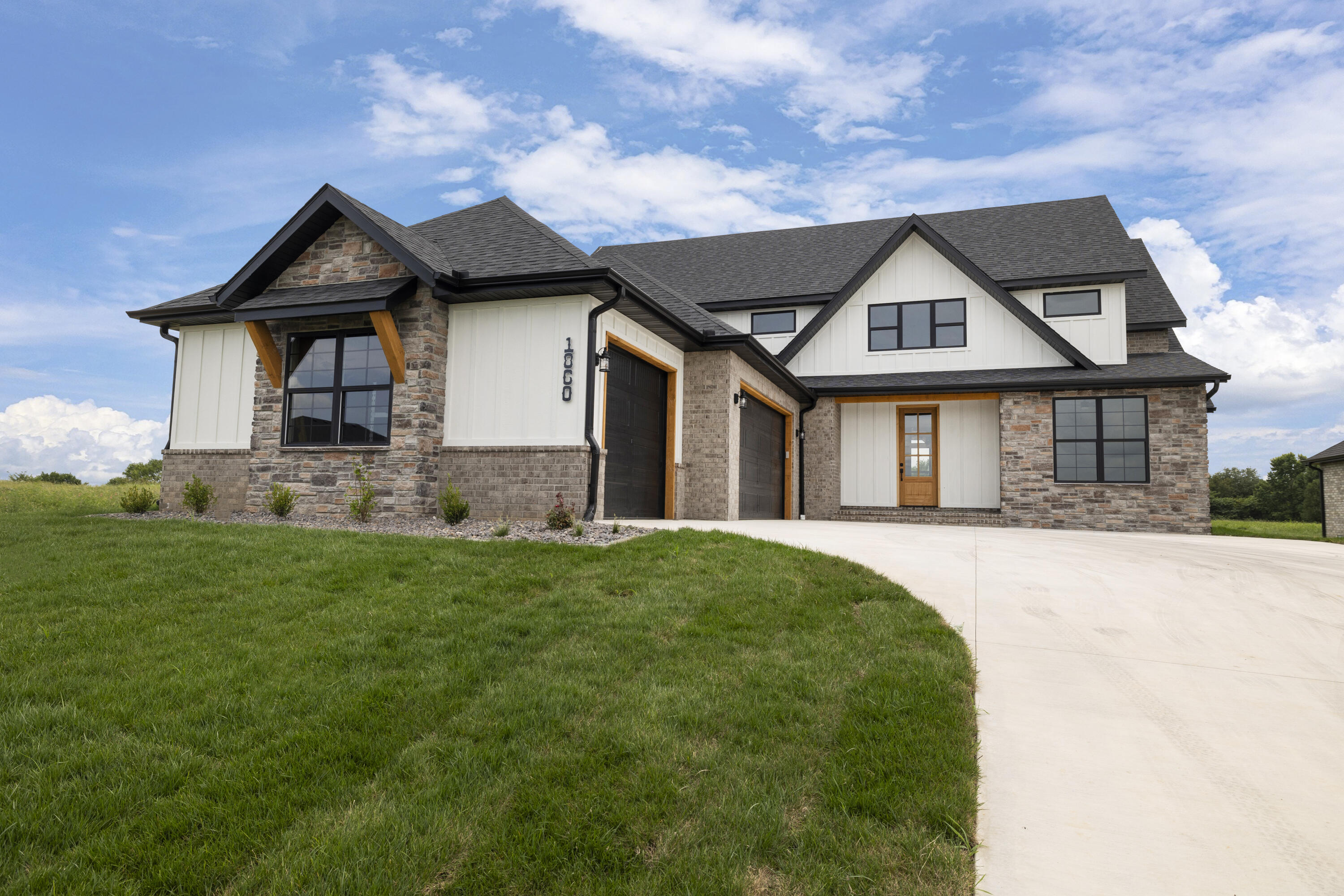 This beautiful home from Third Day Built is so inviting.  The living area boasts a huge cathedral ceiling with a showcase fireplace.  The dining area has a door leading to the covered back porch with gorgeous views.  Watch the kids play in the back, while you are standing at your farmhouse sink in the designer kitchen.  White custom floor to ceiling cabinets with natural wood accents have plenty of room for all of your kitchen gadgets.  The master suite is a dream with a tiled shower with a bench, dual vanities, built in linen cabinets, a separate makeup vanity and a great closet with lots of space.  Down the hall is a generous laundry room with tons of hanging space.  On the other side of the home you'll find three additional bedrooms and a full bathroom with dual vanities.  One of the bedrooms even has a door leading to the back porch.  Heading upstairs you can't help but to notice the handcrafted railing that spans the entire living area giving the upstairs a great view of the downstairs from the balcony.  There is a full bathroom and a large second living area upstairs.  The second living area has a large closet and could be used as a 5th bedroom.  This home is located in North Town Park, one of Ozark's newest subdivisions.  The neighborhood will have a common space including a pool, pickleball court and basketball court.  Don't miss out on your dream home!
