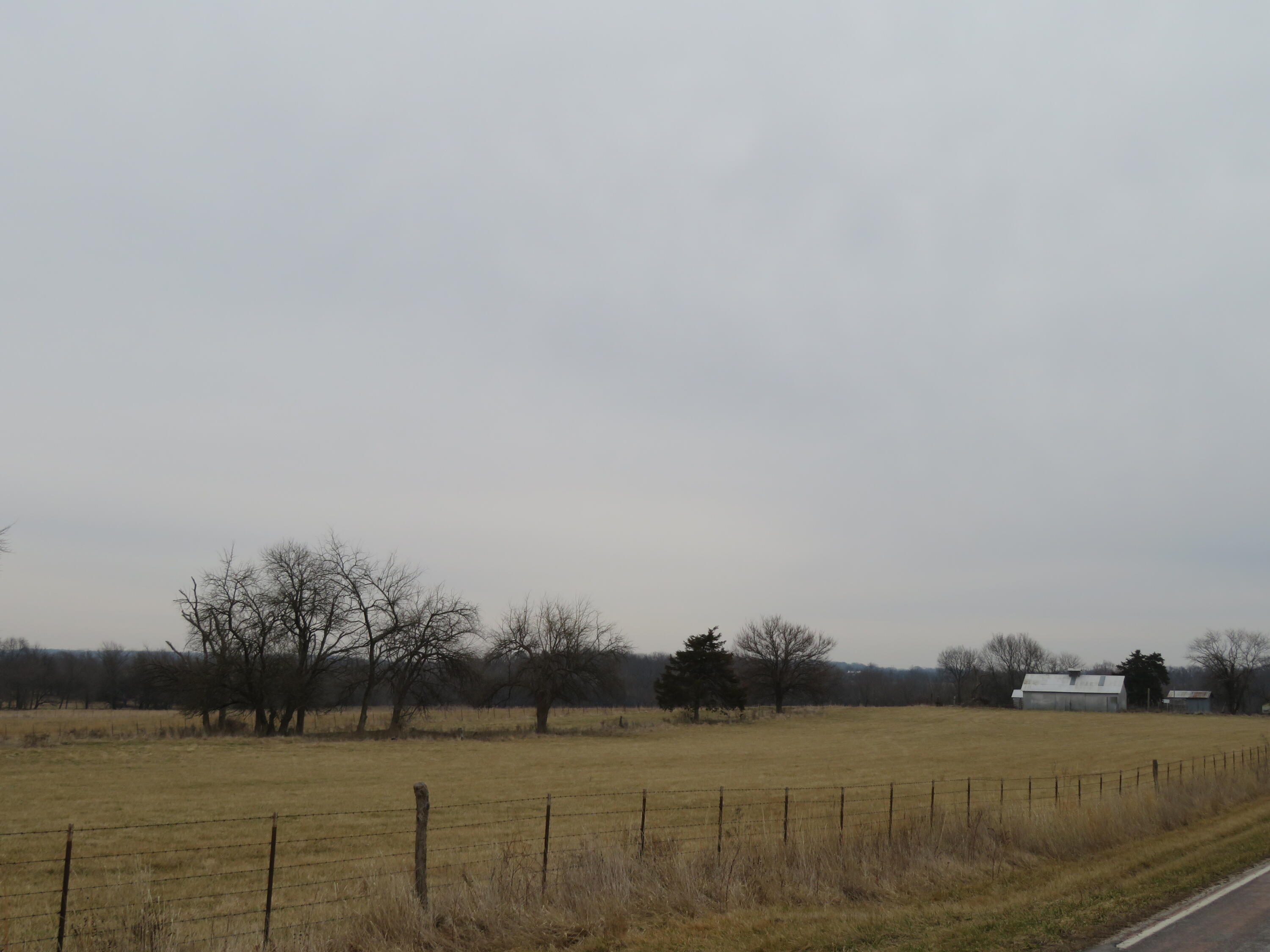 This is the first time this parcel has been available  since 1867.  It has been family owned since that time.  80 mostly open acres of  farm ground. Presently in permanent pasture buy in the past has had corn grown on it.  Property has a nice pipe pipe corral with sort pen as and holding pen along with a working area , ground trailer load out and a semi load out. There is a small pond on the property with a creek bisecting the land.  It has a good perimeter fence and limited cross fencing. There is a well  and electricity on the property .  There is a couple of older barns one is 28x40 and the other is 27x24.  Has a 1/4 mile of Highway frontage and is located within 10 minutes  Pomme de Terre Lake , 15 minutes to Bolivar, and 20 minutes to Lucas Oil Speedway in Wheatland. Property can be used for crops, cattle, horses or  development.