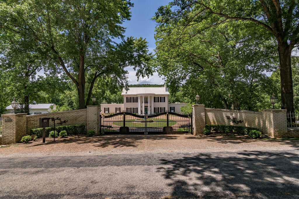 Gated One-of-a-Kind Lake Front Estate in the Heart of Branson!  Walk to the Water's Edge, Park-Like Setting, Dream Vacation Home or Spectacular Primary Residence or Retreat.  This Amazing Colonial Home (approx 10,620 sq ft) also includes a Great Carriage House (approx 1,800 sq ft), Tennis Courts, Elevator, Sprinkler System, Home Gym, Steam Room & Sauna, Viking 6 Burner Gas Stove, 2 Offices, Formal Dining Room, Workshop, Pool (needs updated), Gas Fireplaces, and so much more!  Priced to Sell Fast.  Must See Now!  Won't Last.  5 mins to Branson Landing.  8 mins to Cox Hospital, and less than 20 mins to the Airport.  Memories to be made for you and your family.