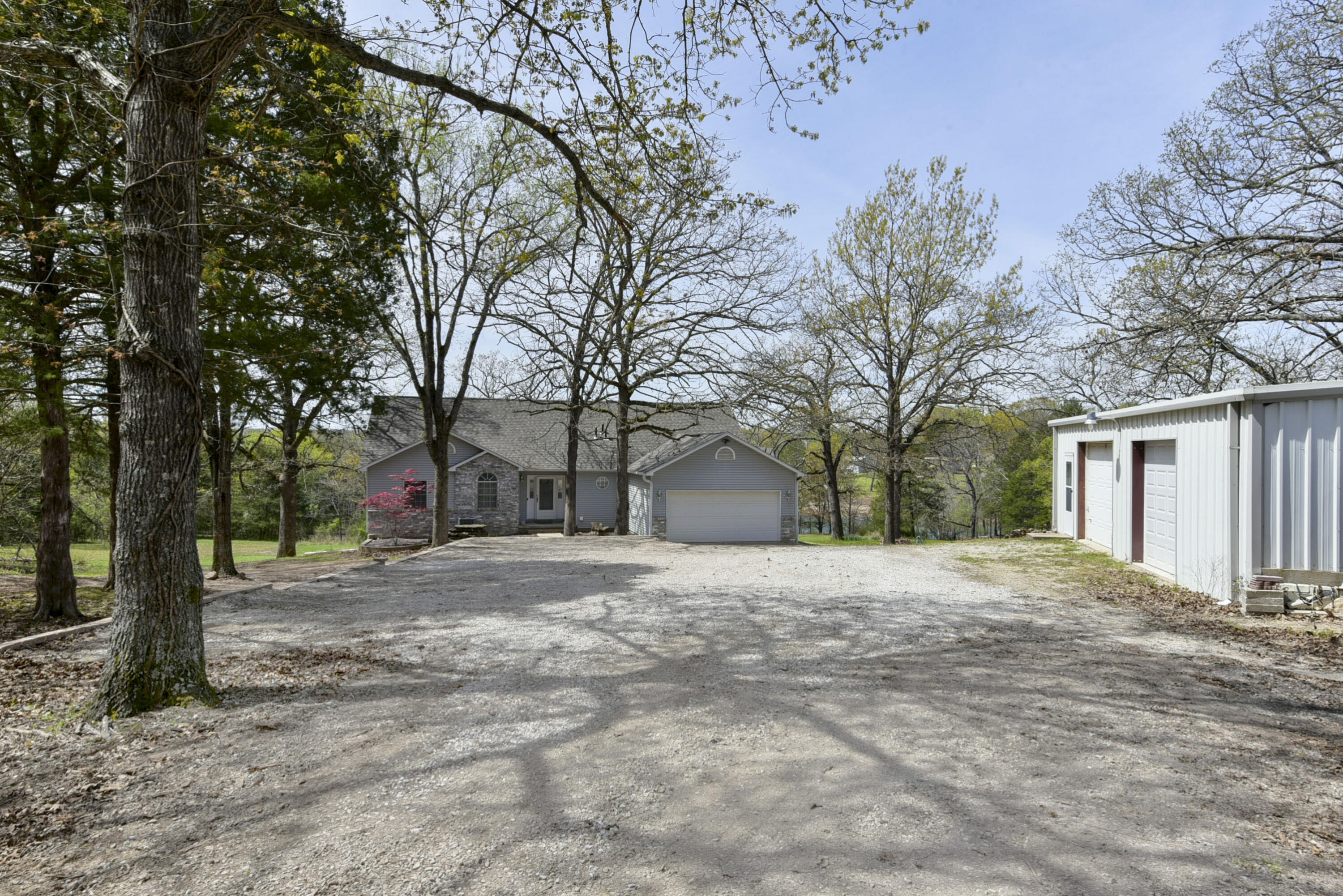 Take a stroll down Dazi Lane to your 2 ACRE slice of TABLE ROCK LAKEFRONT paradise. Amazing views, a 30x40 SHOP & a GENTLE WALK to the WATER's edge. So much privacy & so much room for activities. Vaulted ceilings, modern lighting, luxury vinyl & oh that leathered granite in the entertainers kitchen. Tastefully decorated & recently updated this 3 bed, 2.5 bath ranch has it all!! The spacious owners suite & laundry are  on the main floor & the additional 2 beds, family room & atrium with water feature are tucked lovingly in the walkout basement.  The foundation is poured concrete & the build date is 1995. Furnishings are negotiable. A few hundred yards to Campbell Point Marina for Lunch, Launch & the Possibility of a Boat Slip Lease!