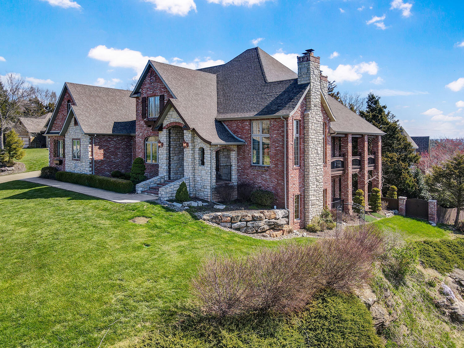 Immaculate custom ''Dream Home'' built in 2004 but so meticulously maintained it still seems just like new. The builder and his family were the original occupants and pulled out all the stops! From the beautiful views of this corner lot that is elevated ''on the bluff'', to the hand-finished wood floors, this walk-out basement home surprises and delights. The 9 foot to 18 foot ceilings create an airy environment filled with natural light. The dine- in kitchen features custom cabinets, granite countertops, an island, bar, pull out shelves, pasta sink, walk-in pantry, dining nook with bay windows, and stainless steel Jenn Air range. The elegant and spacious primary bedroom on the main floor has a sitting area, tray ceiling, walk-in closet and master bath with vaulted ceiling, jacuzzi tub, his and her vanities, a makeup vanity, & large walk-in shower w/dual shower heads/jets. Another unique feature is a second bedroom suite on the second floor with its own private full bath and walk-in closet. The oversized 3 car garage has 9 foot doors and is heated and air-conditioned! Buy with confidence as the roof is only 5 years old. The list of amenities seems never-ending so you can live your best life in this Rivercut Golf Course community.