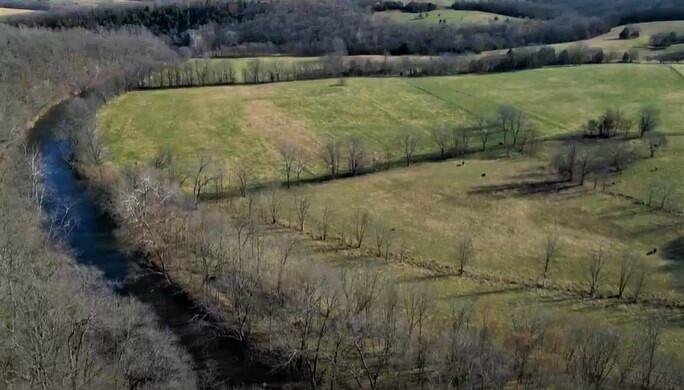 Beautiful Ozarks farm for sale in Wright County on Beaver Creek! 268.5+/- acres with nearly 3/4 mile of river frontage and incredible views! Approximately 75% open and in pasture, 35+/- acres of bottom ground, and 60+/- acres that is hayable. The remainder is wooded, lots of mature timber, and great wildlife habitat. Fenced and cross fenced, working corral with alleyway and squeeze chute, 3 automatic waterers, 2 year-round springs, 1 wet weather spring, and 2 ponds. There are 2 older homes and a barn (structures given no value), with 2 wells, and many great building sites. The owner can sustain 75 pairs year-round. An average weather year can produce 300 round bales in the first cutting. Great hunting property, and the farm connects to 1,000s of acres of Mark Twain National Forest on the south and east sides. This section of Beaver Creek has great fishing, gigging, and swimming, and is locally known as ''Patterson Hole'', and even has 2 spots to put your boat in. There is a beautiful bluff overlooking the river on the north end. This Southern Missouri farm is truly beautiful and has it all with great water, rolling pastures, bottom ground, hunting, and views! Only about 1 mile from paved highway, 30 minutes to Mountain Grove, 45 minutes to Lebanon, 1 hour 15 minutes to Springfield, 2 hours 45 minutes to St. Louis.