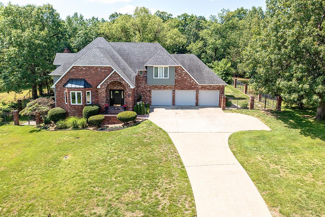 Contemporary home with open floor plan, wood floors, high ceilings, two fireplaces and lots of windows overlooking pool and large front yard. New carpet in basement and on stairs. Kitchen includes a large center island, double ovens, separate pantry & coat/shoe nook off garage. Home includes 3 living areas and a kitchen eat-in area. The primary suite includes walk-in shower, tub and large closets. The walkout basement includes family room with second fireplace, exit to one of the two patios and an unfinished room which is perfect for storage. Bedroom in  basement is non-conforming and could be used for an office. The home has utilized all of it's space...multiple storage areas. Home sits on almost an acre that includes an in-ground swimming pool with security fence and two patios.