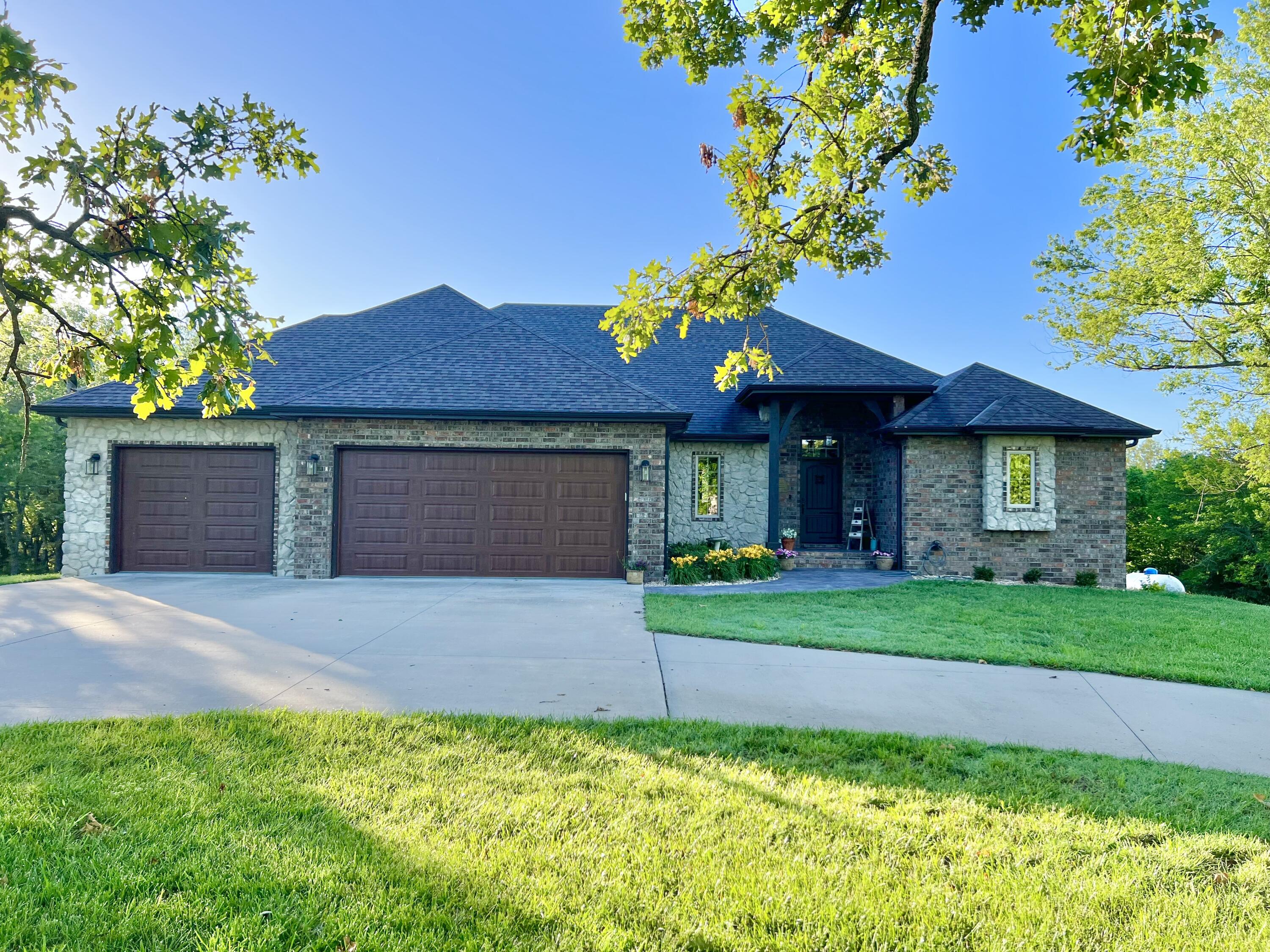 This all brick home located south of Nixa is located on some acreage.  The home features a walkout basement covered back deck, inground pool, covered patio, john Deere room and 3 car attached garage.  The interior has wood floors throughout the 1st floor, spacious bedrooms and walk-in closets.  The kitchen features custom cabinetry, an island, granite countertops and stainless appliances. This home is at the end of a road.  The saltwater in ground pool has ample patio space for entertaining guests.  The basement features a wet bar area and spacious open room with a bathroom and two bedrooms.  Home has a 40 x 80 enclosed shop.  Come take a look and see.