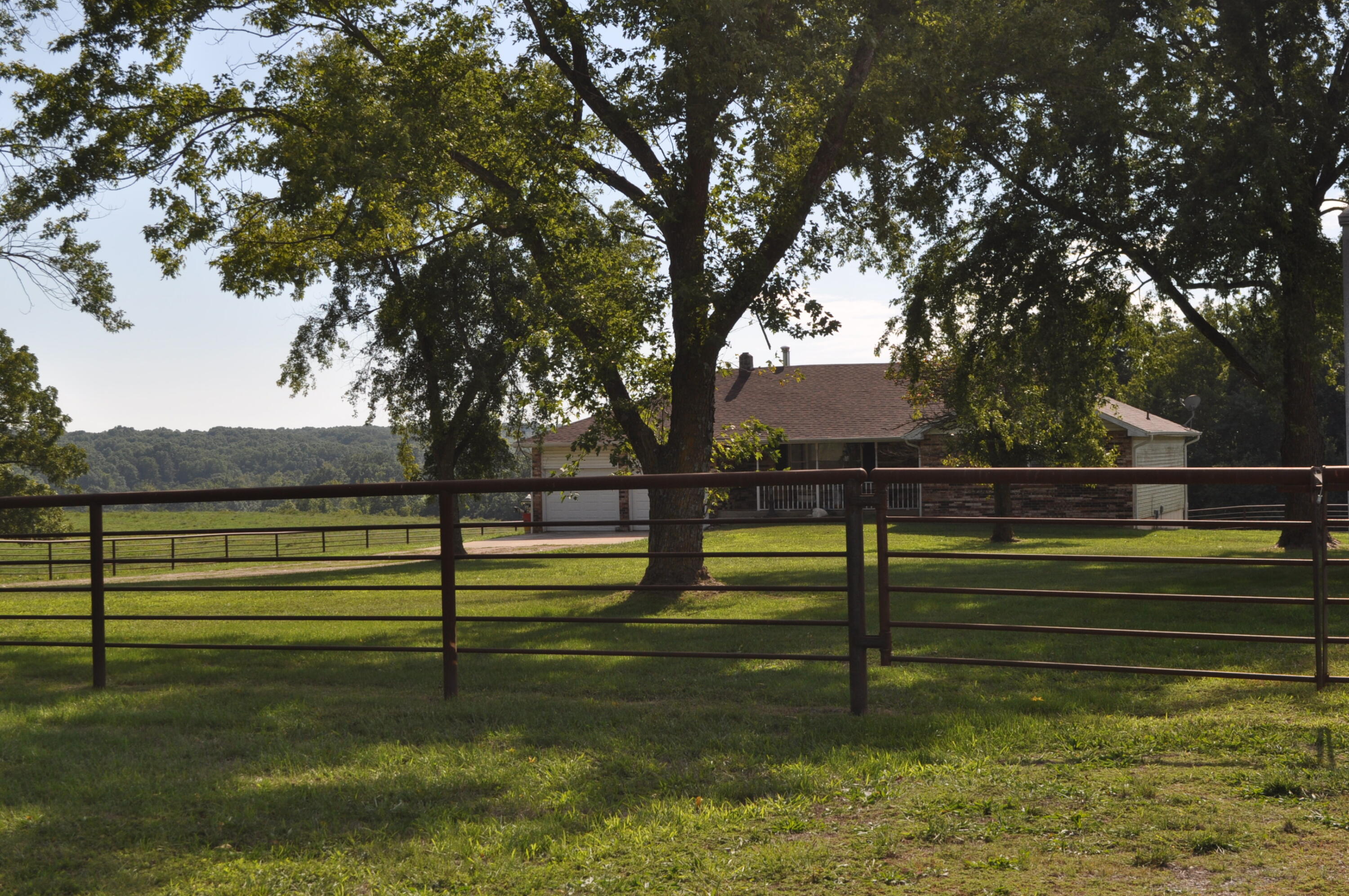 This nice 80+/- acres is very conveniently located just a few miles south of Hwy 60 between Rogersville and Fordland in Webster county. The beautiful sunsets can be viewed from the large wrap around deck on the 4 bed, 3bath home with 2 car garage and full finished walk out basement. The property offers a 40'x60' shop with concrete floors and air conditioned office and tall sidewalls for R/V or tractor storage.  The property includes a multiuse 50'x50' barn with 8 stalls, tack room and wash rack. The property offers several feeding traps with shades, automatic waterers and over 570' of concrete bunks.  The land offers a nice balance of open and wooded ground for both grazing and recreational hunting. This property certainly has something for everyone.