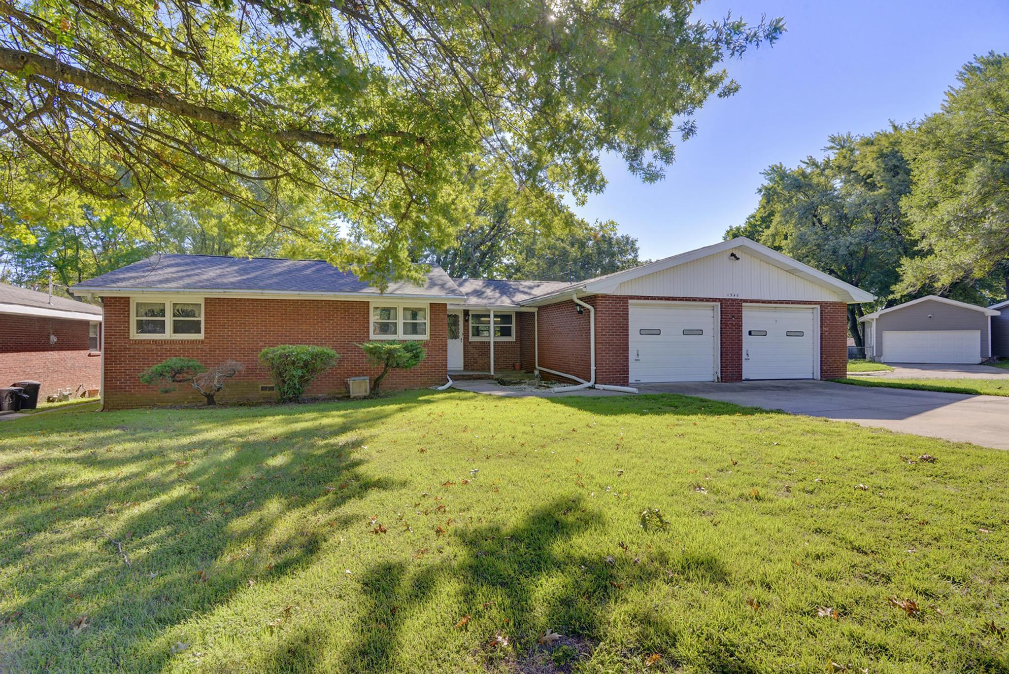 Affordable ALL BRICK home in a great SE Springfield location! Among the updates this home has had are updated windows, new carpet through most of the home, roof believed to be around three years old, updated bathrooms and a HUGE garage with a two-car deep bay making it a three car garage! There are two large living areas including one with a gas log fireplace. Both living areas have new carpet. The  kitchen features updated laminate flooring, a dishwasher, glass-top cooktop range and built-in oven. Carpet covers hardwood floors in the hallway and one bedroom but the hardwoods are exposed in the other two bedrooms, including the master bedroom. The master bathroom has been updated with a modern vanity, mirror and medicine cabinet plus updated flooring. The hall bathroom also has modern updated cabinetry and flooring along with a huge walk-in shower with glass doors. Out back are two patio areas, mature trees and a convenient storage shed next to the home. (Shed out in the yard does not stay). Dont wait, call today for your private tour! HOME HAS POTENTIALLY SIGNIFICANT STRUCTURAL ISSUES. A COPY OF PREVIOUS INSPECTION IS AVAILABLE. PLEASE PERFORM DUE DILIGENCE ON THIS ISSUE PRIOR TO MAKING AN OFFER. HOME SOLD AS-IS, WHERE-IS. SELLER WILL MAKE NO REPAIRS.