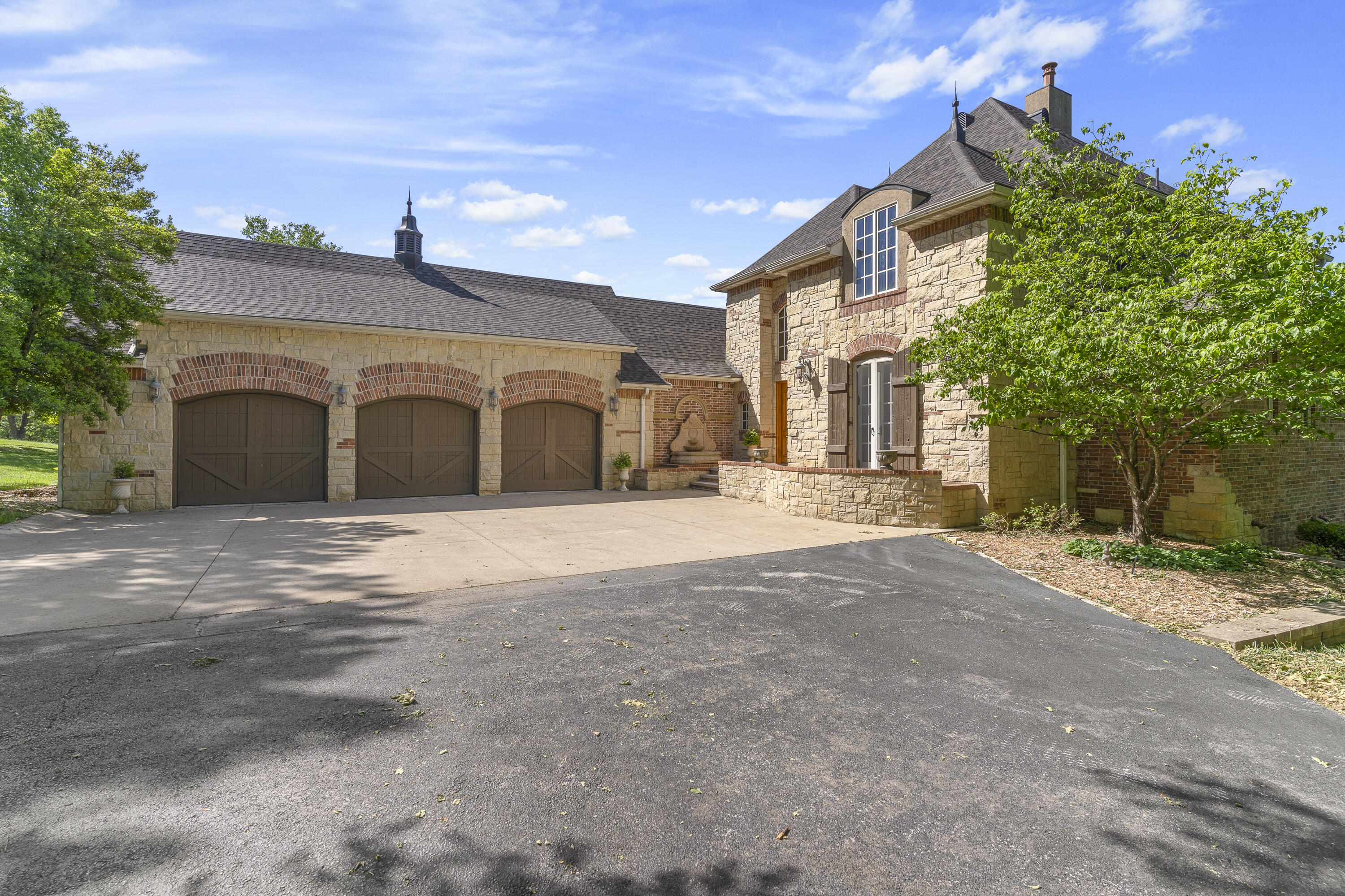 Schools are Mathews Elementary K-4 & Inman Intermediate 5-6As you drive into the stone & brick pillars with a winding driveway you know this home is special. This gorgeous custom built one owner home has so many special features. As you walk up to the home you are welcomed by a fountain at the front door. The solid wood front doors open to a large entryway with tall ceilings & slate floors. Walk into the living room with a 2+ story ceiling & window with custom made drapes & a custom stone gas log fireplace.The kitchen is a cook's delight with lots of storage.  A large center island with a prep sink & butcher block top is perfect for meal preparation. There's a Blue Star 8 burner gas stove w/ double ovens & a pot filler & custom tile work over the stove. Tons of cabinets with granite counters & a large farm house sink. Pantry has pullout shelves. A built in desk w/ overhead cabinets & seeded glass. It has a Sub Zero refrigerator. The eating area has a custom wooden ceiling treatment. A hearth room offers a quiet spot to sit back & relax next to a stone & brick gas log fireplace. Throughout the home is real hickory wood floors & wood beams & crown molding & 6 panel wood doors. Plastered textured walls w/ a special glazing. There is central vacuum on all 3 floors & surround sound. As you enter the formal dining there are 2 concrete pillars. It has a barrel shaped ceiling with 3 way lighting & a beautiful chandelier & wall sconces. A large window offers lots of light & has a custom window treatment & wallpaper. The utility room has a sink & extra storage. The 1/2 bath has wallpaper & a pocket door w/ a special paint treatment. As you enter the master bedroom there is a niche area that is perfect to showcase that special piece of artwork. A tall custom rustic alderwood door leads to the master bedroom w/ doors to the deck. The master bath is a retreat with a  tall ceiling, wooden beams, crown molding & travertine floors. A large vanity with 2 sinks and marble counter