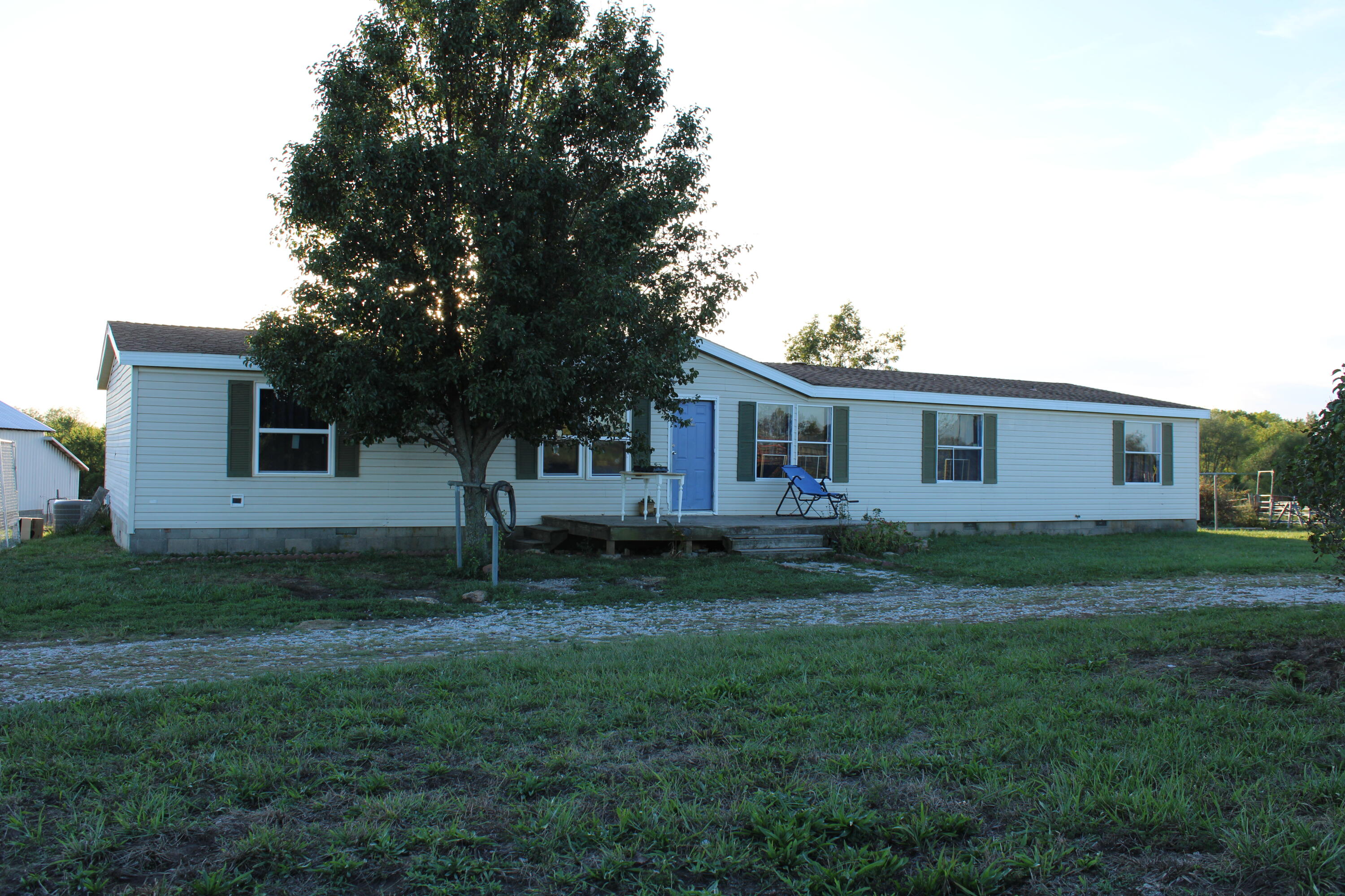 This 1998 manufactured home has 5 bedrooms and 3 bathrooms and sits on 5+/- acres. It has plenty of room for the family and has plenty of open space to have your mini farm. It has a 30 x 40 barn/shop that has a 15 ft lean off of the west end that is perfect for a couple horses to get in out of the weather. The home has a large open kitchen and dining area with plenty of room to cook and entertain. There are no restriction to keep you from adding anything you would want to add on your mini farm. It is located approximately 2 miles to the northwest of the Lowry City, Missouri on CC Hwy. The town is just a short drive to the city of Clinton, Missouri that has plenty of shopping and places to eat. Clinton is also home of Golden Valley Hospital and has several walk in clinics if needed. If you are looking for one of those hard to find smaller properties then you will want to check this one out. It has open pasture and is located close to a state highway with easy access. This property is located close to Truman Lake, that is know as one of the best crappie fishing lakes in the entire country. There is also plenty of public land that you can hike or hunt on as well.