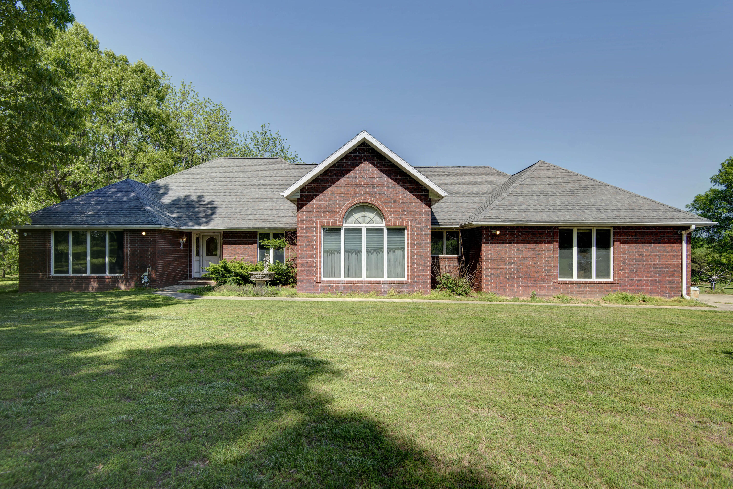 Lovely all brick home sitting back off the road on approximately 51.77 acres of 1/4 cleared & 3/4 wooded Serenity!  Relax in the conditioned sunroom overlooking the inground pool & pond or take up some new hobbies in the 30x50 shop building w/ workshop, enclosed lean to for boat  and carport for RV & RV hookup!  Experience low utilities with the geo-thermal heat pump!!!  You'll love the open split bedroom floor plan offering almost 3000 sq ft on one level, Andersen windows, a formal dining room/office, formal living room w/ lots of windows, spacious family room w/ laminate floors, tray ceiling w/ indirect lighting & brick fireplace w/ pellet stove insert!  The wonderful kitchen displays  large dining area w/ bay window, snack bar, newer stainless steel appliances, lots of cabinets with some pull outs & pantry!   The master bedroom exhibits 10' ceilings, beautiful windows, master bath w/ corner jetted tub, double vanities, walk-in shower and large walk-in closet!  Be safe during storms in storm shelter located next to shop building!