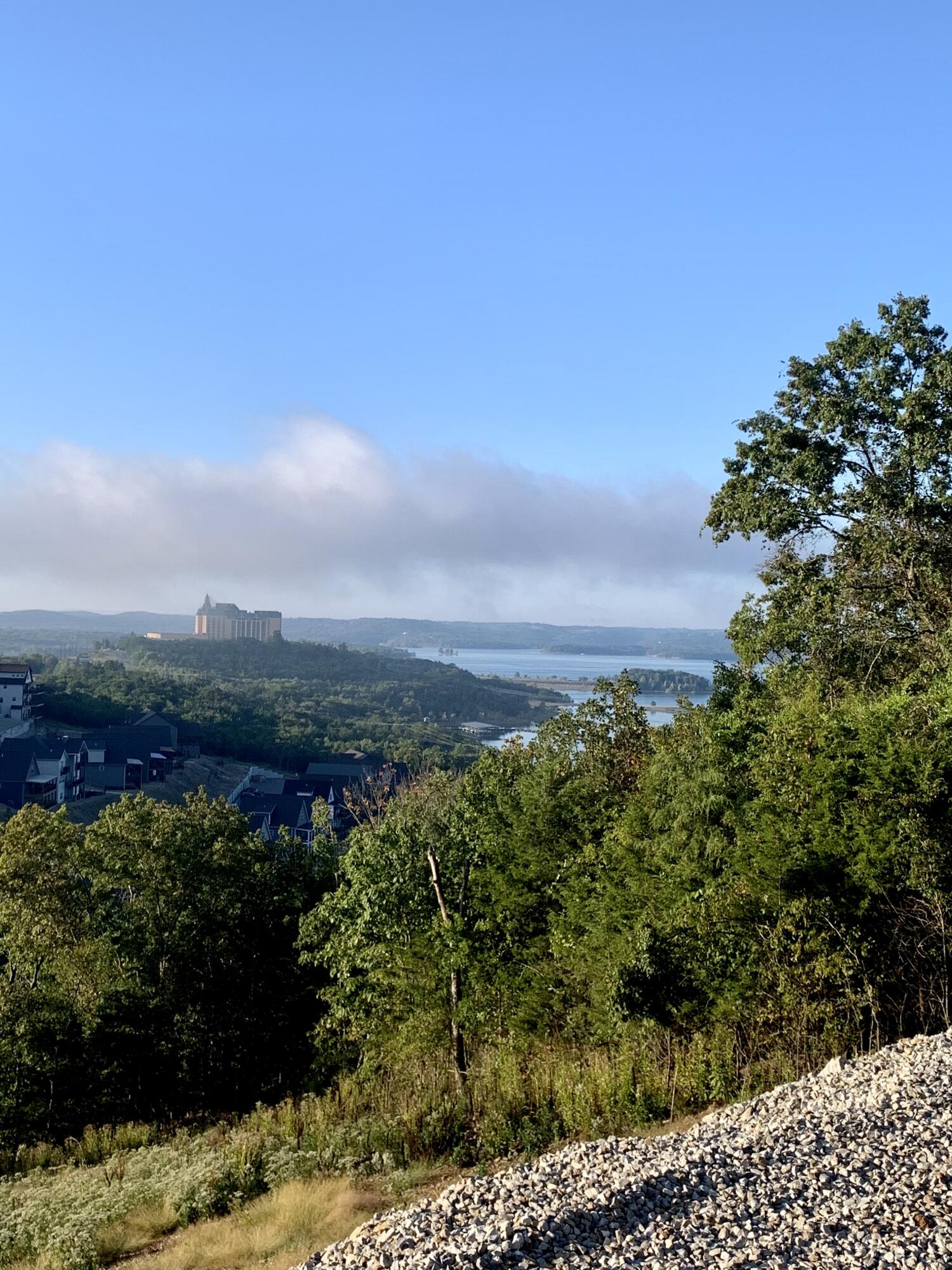 Incredible 3 level home (zoned for nightly rental) in the much desired Chateau Mountain Phase 1 community.  Property is set to be finished April 2022. Featuring 6 bedrooms - each with an en suite bathroom.  Lots of windows to show off the beautiful Table Rock Lake view. Fantastic location - close to Silver Dollar City and the 76 strip in Branson. Indoor and outdoor pool within walking distance as well as half-court basketball court, and regulation size corn hole area. Playground also included. Property is located in an Opportunity Zone.