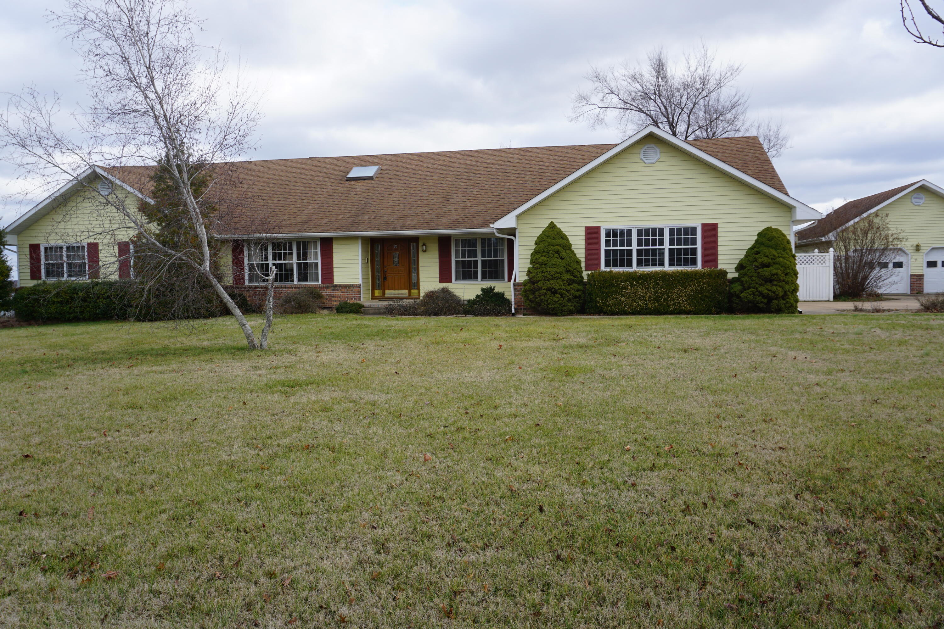 Enjoy both town AND country living in this beautiful, custom one-owner home!  Built right on the very edge of the city limits on almost 4 acres, it is close to town amenities but peaceful and quiet with lovely, rolling pasture views off the back porch.  Flowering and fruit trees abound - peach, apple, pear, nectarine, apricot!  Blackberry bushes tumble over the fences.  There are even grape vines! Head inside to the beautiful entry. Note the sparkling lighting above and in the formal dining room where a gorgeous chandelier is on full display.  Entertain visitors in a formal living room or the more casual family room where the seller especially loves reading a good book by the fireplace.  The kitchen and laundry room have TONS of cabinets. The bedrooms are spacious and the big windows let in lots of light.  In addition to large closets in the bedrooms, extra storage is tucked all over the place - the hall closet is even cedar-lined! In the master bath, find the hidden pull-out mirror that assists with making sure hair-dos look good from the back. There is even a make-up counter built-in for space to sit while applying make-up for the day. Head up the wide, oak steps to the upstairs to find two more bedrooms, an open area and additional room that are a blank canvas for you to finish out and make your own. Head downstairs to the basement where there is a large, open, heated and cooled space that would make a great home theatre, man cave or teen rec room - you decide! Back outside is the heated and cooled workshop that has a bathroom with sink, toilet and shower.  The garage doors all have openers for easy access.  Don't wait - schedule your showing today!