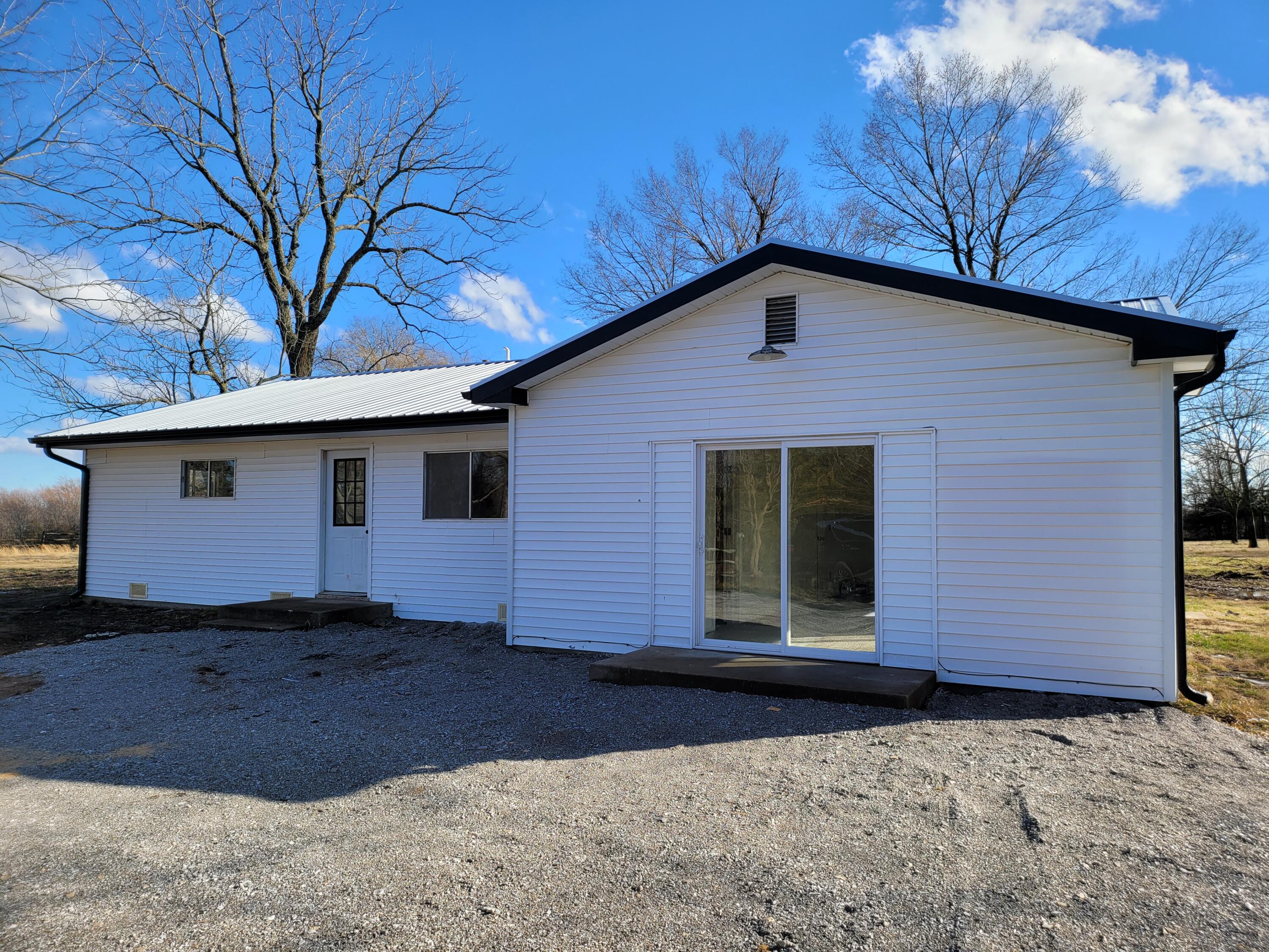 Here it is!  A very nicely redone home with three bedrooms and two bathrooms, large open living room/dining area and a split bedroom plan and best of all it's located on 5 secluded acres in the country.  The 5 acres boasts a pond and a large barn.  Another 19 acres is also available in two separate tracts (MLS #'s 60229224 and 60229225).  This home is located at the end of a long driveway and has a great secluded feel but it's not too far from Highway 60 making it a short drive to Springfield.  The recent updates on the home include a metal roof, an added bathroom (and an updated bathroom), new flooring throughout, a new septic and lots of other upgrades.   There is still a little work to be done, but it's almost complete.  Come and see this beautiful place.  Make your appointment for a private showing today.