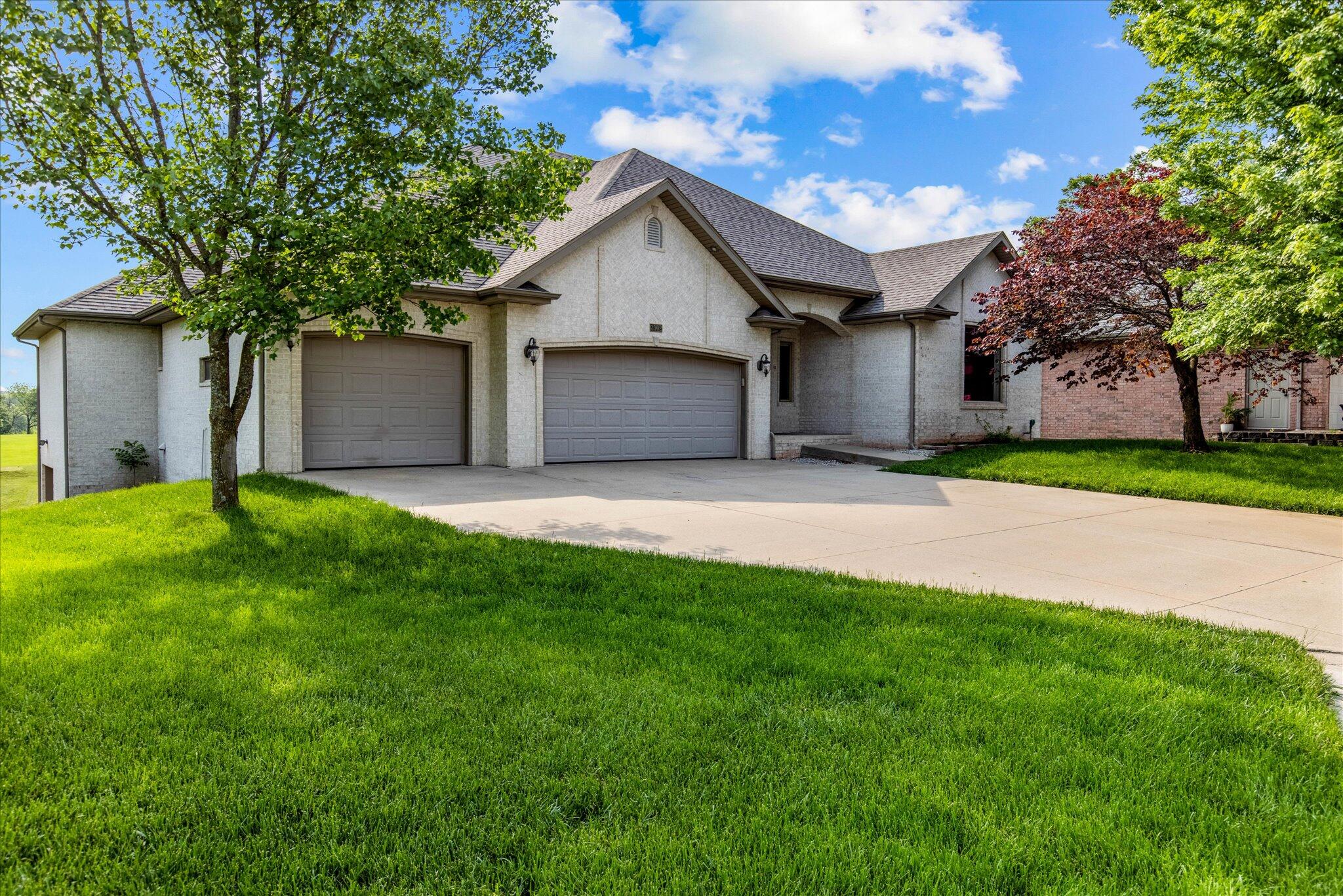Welcome to your own oasis! Located on a golf course in Springfield's beautiful Village on the Greens, you'll love this 4 bed 3.5 bath home. Before you even enter, you'll be taken away by the view of wildlife running through your forested surroundings and this home's stunning curb appeal. Walk through the front door to be greeted by incredible 12 ft. ceilings and floods of natural light throughout. The kitchen is complete with granite counter tops, stainless steel appliances, a walk-in pantry, and a large kitchen island. Sit in the kitchen's dining area or walk out onto the back deck to get a great view of the 7th and 8th holes on the course. Or, if you're having a family meal, you're able to enjoy the formal dining room. The master suite features tray ceilings, a double vanity, separate tub & shower, and a walk-in closet. Other perks of this fantastic home include a storm shelter, stereo system, inground sprinkler system, and a 2 year old roof. Don't miss out on your next home! The loan is assumable at 2.25% for qualified buyers.