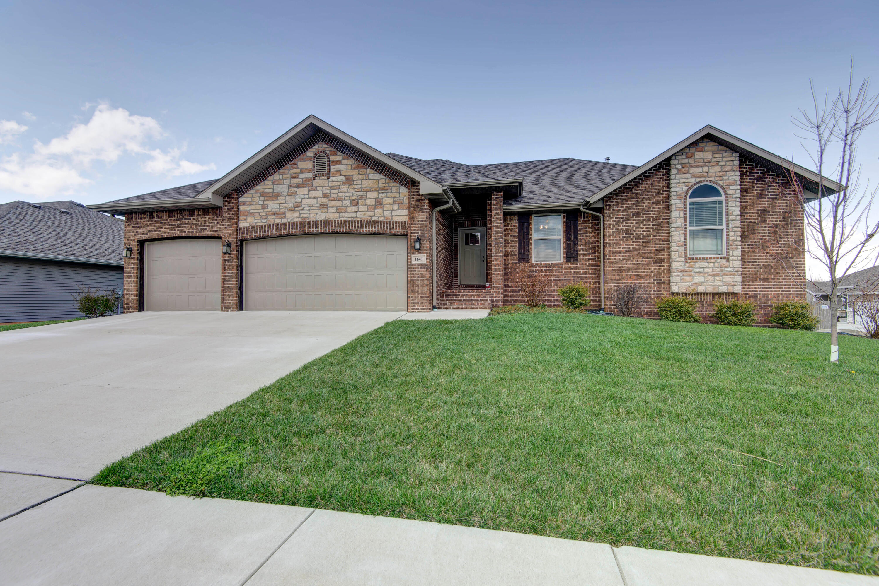 Conveniently located with easy access to Nixa shopping, schools, and Springfield. This 6 BR home offers generous living areas with Certified Green High efficiency HVAC, water heater, and Energy Star Appliances. Main Floor has 4 BRs with Split bedroom plan. Generous main bedroom, en suite bathroom has a tiled Walk-in shower, double sinks, granite counters, & Walk-in closet. Several extra storage areas throughout the home, mud room, laundry, and full pantry, for the kitchen. Island bar in kitchen plus generous dining area and access to covered side porch. Enjoy the colorful sunsets from the covered porch off the kitchen.Open living room, high ceilings, gas fireplace, and easy arrangement for furniture. Window treatments included. Double-pane, tilt-in windows for convenience. Walkout basement has two bedrooms with walk-in closets, bathroom (granite counters in all bathrooms), expansive family room, and covered patio off side door.  Basement has a separate room under front porch that could be used during storms.