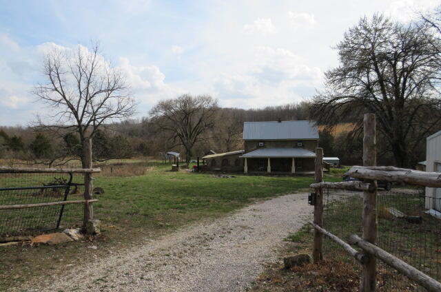 BACK-ON due to no fault of the Sellers-----Beautiful 10 acres with Live Water!!  2 springs and a creek. Almost a 100-year-old farm house with 3 bedrooms and one full bath.  The green house is attached to the house. The 25x40 Metal pole barn/Shop also offers a kitchen inside. This hobby farm is great for the family, with a well-established garden area, apple, pear and plum trees, lots of berries and grape vines. The fencing is all new and some is woven wire for sheep and goats. There is a large and wonderful chicken house completely fenced.  The cellar is great form storms and the room on top of the Cellar is all new and great for storage. Google map will not take you to the house. Being sold As-Is