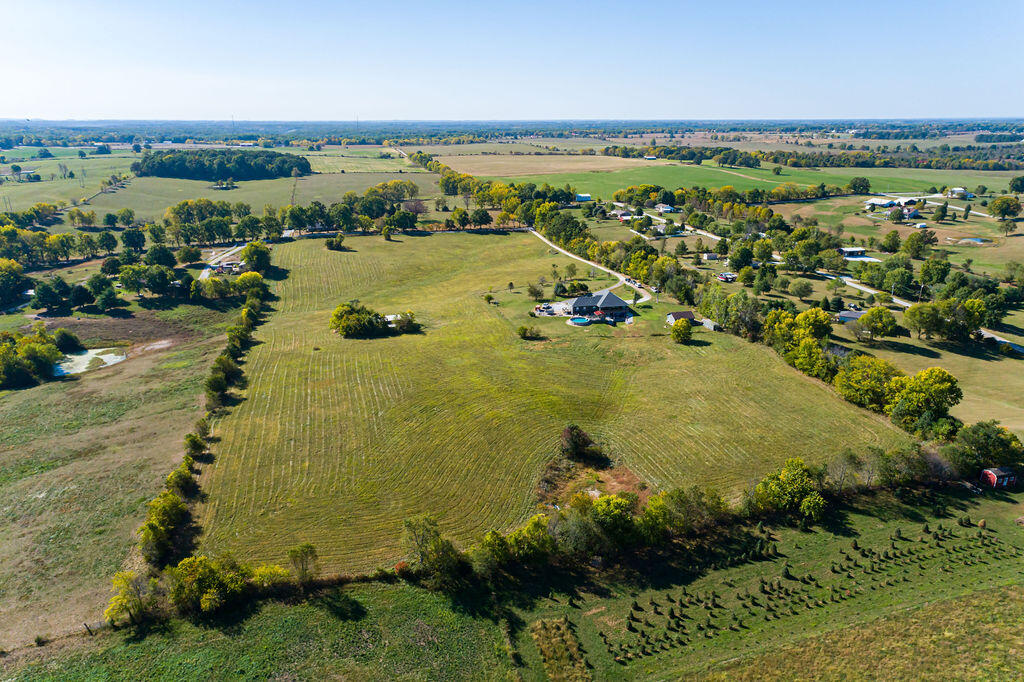 Spectacular Custom Original Owner Home that sits on 12.5 Acres M/L.  Showcase Private Drive, Pond, Fabulous Location, Custom Hickory Cabinets, Oval Tub, Marble Shower, Blown Insulation, 30x30 Attached Drive Thru Garage with 16x8 Overhead Doors, 27x24 Detached Shop or Garage, Hay Barn or Storage Building, 43x11 Covered Deck, Game Room and Bar, Open Floor Plan, 2 Master Suites, Can be 4 or 5 Bedroom with Alterations, Plumbed and stubbed for 2 more Bedrooms on Main Level if needed. Above Ground Pool, Gazebo, Ozark Schools. Room for your Horses or Animals, Great Pasture. Must See Now! Priced to Sell Fast. Won't Last.