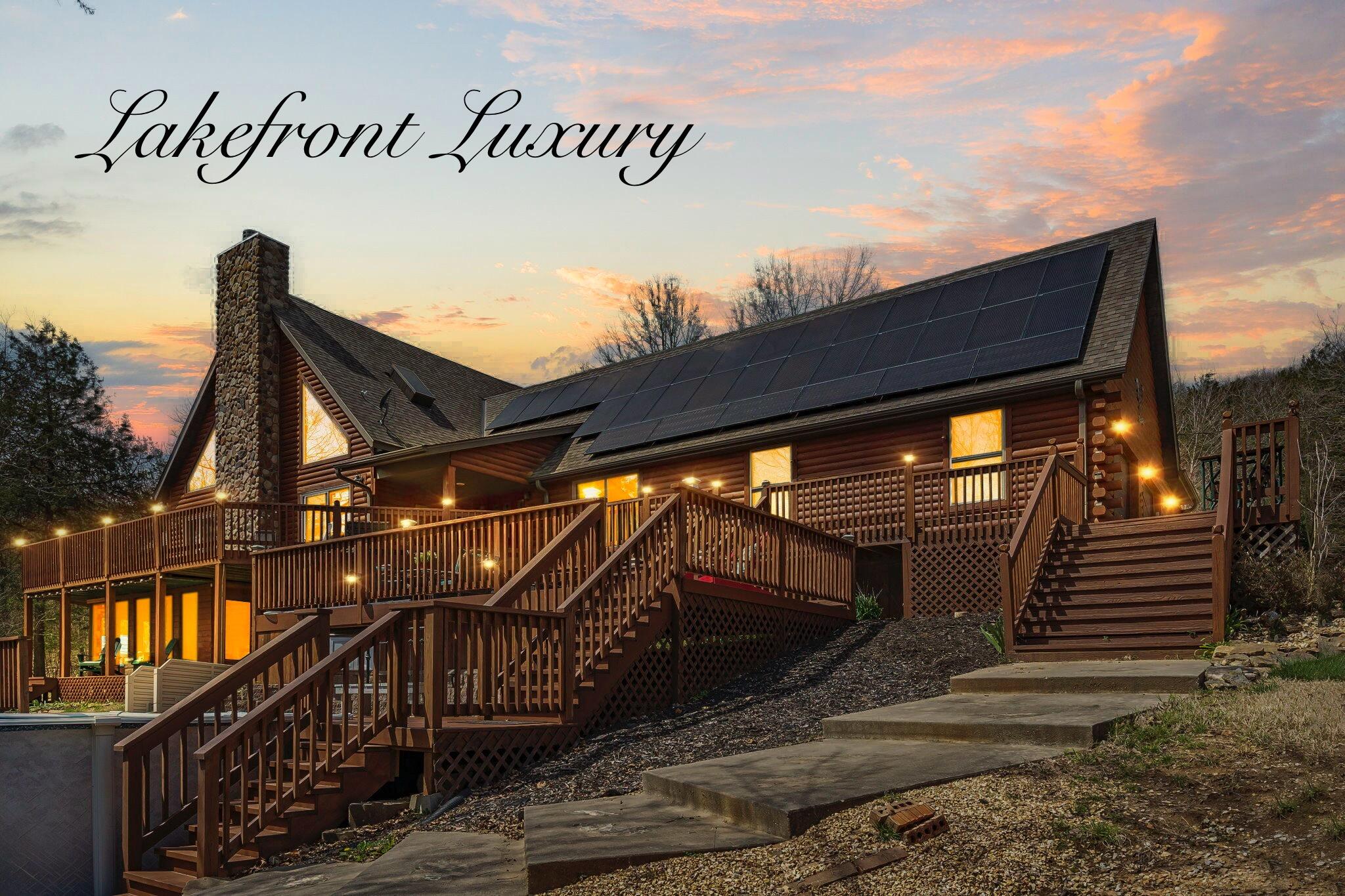 Welcome to this pristine, fully furnished, lakefront log home set on over 5 acres! Truly a paradise with its beautiful lakefront view, expansive decks, cathedral ceiling, stone fireplace and exposed wooden beams, not to mention a sauna, hot tub, and pool! Updates galore include new flooring, double pane Anderson windows and sliding glass doors, a newly heated sunroom, epoxy stone coated kitchen countertops, quartz throughout the bathrooms, and a soaking tub.  A new LG refrigerator, furnace( which was just serviced March 28th), 50 gallon water heater, air filtration system, as well as a Culligan water softener system are just a few more new upgrades. The crawl space has been rubber coated to prevent radon issues, the exterior logs have just been sandblasted with a 15 year warranty, and a brand new roof was installed last summer (2023)! The solar panels are owned and only 2 years old with a 25 year transferrable warranty! A new $11k Generac generator serves as backup power for the home and can be set to only service half of the home at a time if desired. The garage and workshop floors have been polyurethane coated to prevent cracks and keep dust to a minimum.  Enjoy the hot tub or your 28' x 5' swimming pool overlooking the lake, both new within 2 years and with warranties! A new screened in porch with fireplace has also been added next to the pool! Use your Polaris RZR UTV to haul your paddleboat, kayaks, or canoe down to the lake, trailers included! Its just a few steps off the deck right to the water! Grow some vegetables in your already fenced in garden boxes. The wood sided 10x 20 building comes with a complete porch set up and front door entry! Need to mow? Your Troy Bilt mower awaits you! Have a boat or RV? You've got a pad ready and waiting, as well as a very well constructed 2 car carport. Pizza oven, grill, hammock, 3 fire pits, 3 fireplaces, and so much more! 100% move in ready, down to the dishes and silverware! This one is a dream come true!