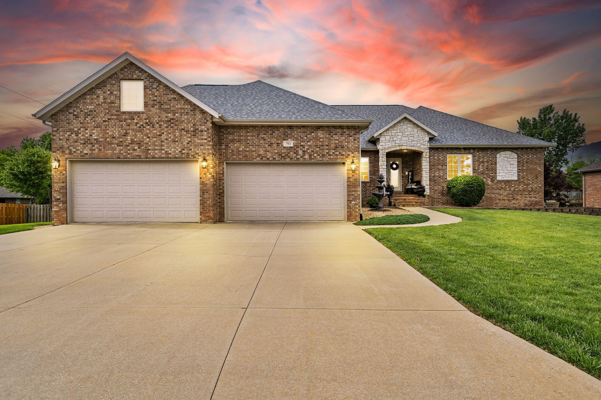 Discover this stunning all-brick home boasting a walkout basement and a spacious 4-car garage in the heart of Nixa!Step into the main level to find two cozy gas fireplaces, one gracing the living room and another in the kitchen/dining area. Granite countertops adorn every surface, while heated floors in the main floor bathrooms ensure a touch of indulgence. Stay connected with the convenient intercom system.Hardwood floors flow throughout most of the space, complementing the three bedrooms, an office (which can easily convert into a fourth bedroom), a well-appointed laundry room, and 2.5 baths.You can go into the walkout basement to discover a sprawling rec room with a pellet stove for cozy gatherings and a fully equipped wet bar boasting a dishwasher, disposal, microwave, and refrigerator. Two additional bedrooms offer ample accommodation, alongside a versatile non-conforming room currently serving as a gym.Experience movie nights like never before in the soundproof media room, equipped with built-in speakers. Completing the basement area is a full bath, a heated and cooled workshop, and a convenient John Deere room.Outside, a spacious fenced yard awaits, accompanied by a partially covered deck spanning the length of the home and a patio for outdoor enjoyment. The home's construction boasts foam insulation, ensuring exceptional energy efficiency and lower utility costs. A new fiberglass shingle roof was installed in 2023 with a transferable 50-year manufacturer's warranty and a 10-year installer warranty. Don't miss the chance to make this exceptional property yours. Schedule your private showing today!