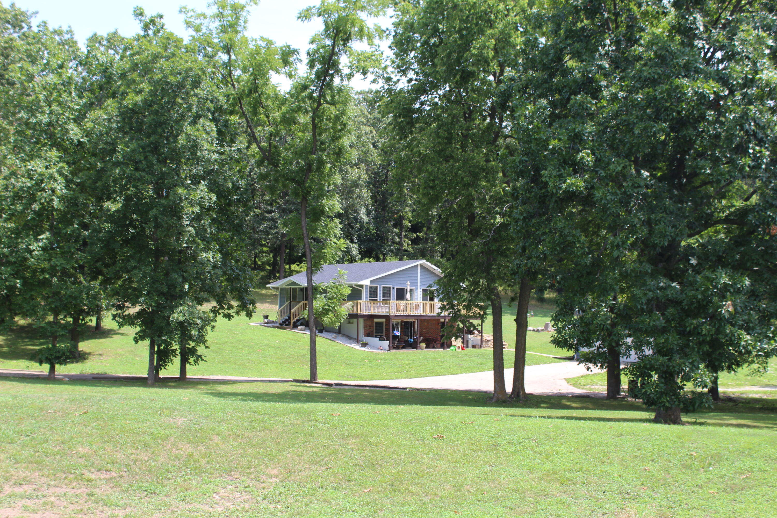 OPEN HOUSE This Sunday AUGUST 6TH 2-4PM.  Come check it out while it's open.  Get to packing y'all because this place is the peace and quiet that you've been looking for!!! Super gorgeous country home with picturesque setting with acreage, shops and sheds galore,  away from everything but close enough to Cassville for shopping or dining. This cute country home features a brand new roof, brand new siding, brand new deck railing, along with  beautiful hardwood floors, custom cabinets, granite countertops throughout.  Upstairs enjoy a living area, a chefs kitchen, very nice master suite with a spacious master bath with walk in closet. Downstairs enjoy 2 more bedrooms, a large family room, an office, bathroom and a large laundry area that can also be used as a mud room.  That's not all.  This place does not shy on the shop space.  This property includes a 40X60 Shop with concrete floors with 220 electric and plumbed,  a detached 2 car garage, a chicken house, and a 2 bay car or boat storage building. This place is a must see! Sellers are moving due to employment. Come grab this up before it is gone Again, Open House Sunday, August 6th at 2-4pm