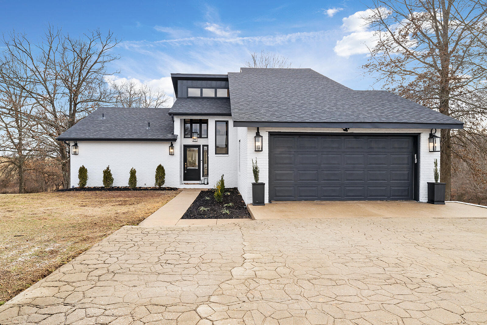 Wow! New price on this totally updated charmer! One lucky Missouri buyer will come away with this dream home at 352 East Old Bittersweet Street in Nixa! Offering privately gated, 15 tranquil acres nestled into the Ozarks hillside with close proximity to Branson entertainment, great shopping, golf, and a quick trip to the nearby Table Rock lake. This property is a rare find, and the house itself has luxurious features, a spacious floor plan, and a chic style!  All top of the line finishes on this completely renovated home.  No expenses were spared! This 4 bedroom, 3.5 bath home has all new plumbing and wiring, new roof in 2022, brand new paint and flooring throughout. The kitchen was taken down to the studs and reconfigured. The new design allows for easy flow between the living room and kitchen making it a perfect space for entertaining. The beautiful island is the focal point of the kitchen and is surrounded by marble counter tops with a gorgeous backsplash, all new appliances, farm house sink and high end light fixtures. It truly looks like it came right out of a magazine. The master suite has soaring ceilings with a brick fireplace and and en-suite that has been reworked to create a beautifully, bright and open feel. Right outside the bedroom you can relax in your private, heated sunroom equipped with a hot tub. Upstairs are two spacious bedrooms, full bath and cozy loft. One of the upstairs bedrooms has a hidden play room attached, every little kids dream! The basement feels like you are walking into a spa. It features a guest quarters, electric fireplace, bar and gym.  Every window has majestic views, of treed countryside.  Bring the animals, the property is fenced.  The South pasture includes a small barn and frost free waterer. Home is connected to city water and sewer! Massey Ferguson 40 tractor with brush hog and Toro zero-turn mower included. Get the country lifestyle while being only minutes Main St. Call today for your private showing!