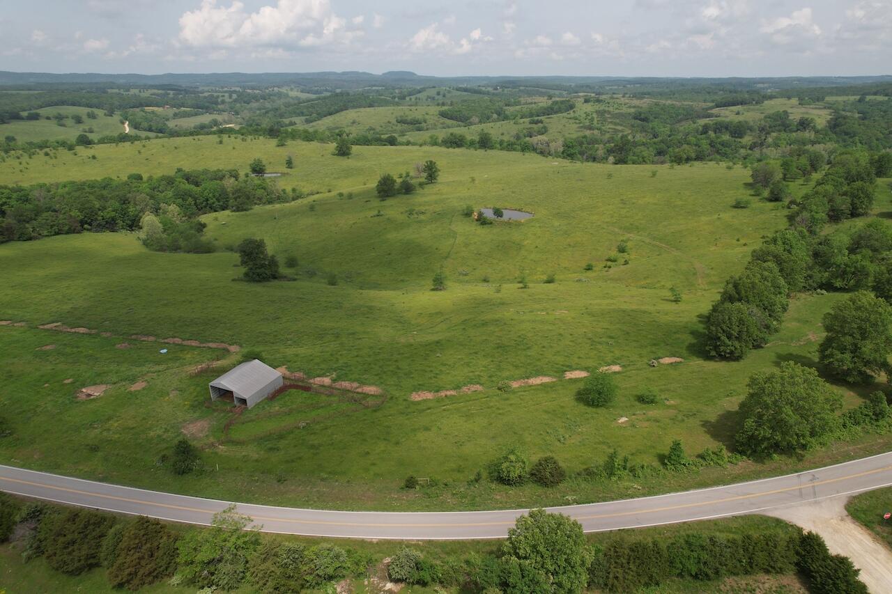 Property just sprayed with Dura-core and Remedy in July.Build your Ranch in the Ozarks on these 295 acres. Long range views, several building sites. Hay barn-calving barn, pipe corrals, pipe corners and braces. Small creek on one side and a portion of the Little North Fork of the White on the other side. 5 Ponds, Spring trough. Perimeter fenced with 5-barbs and cross fenced. Over a mile of highway frontage on JJ. Presently used for cattle but could be divided into smaller parcels with the entrances 17 miles to Ava, 3 miles to  Thornfield convenience store-cafe and a farm store to buy feed, fertilizer and farm supplies. ready for your cattle has not been grazed since April.Contact listing agent for showing.
