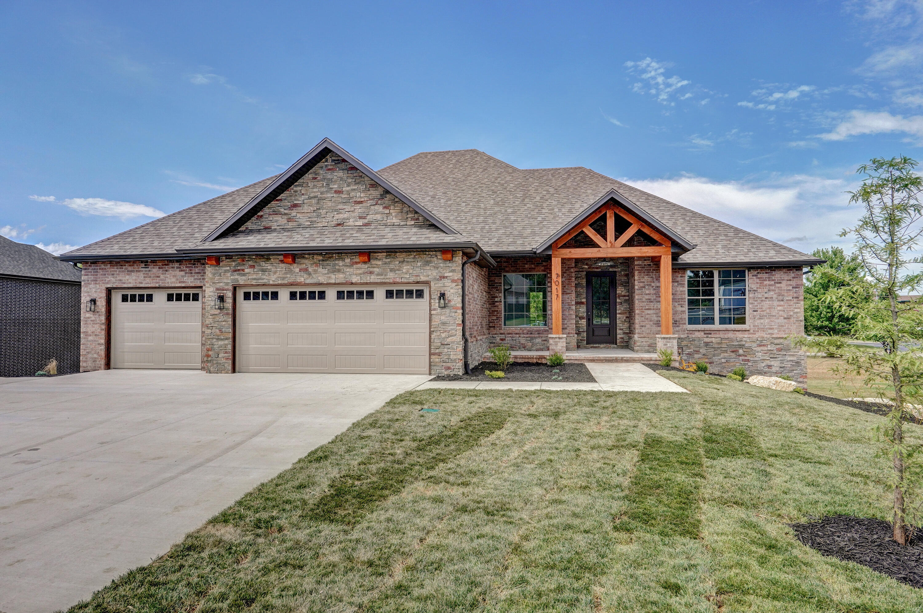 *OPEN HOUSE SATURDAY 8/20 from 2-4 PM!* Welcome to this beautiful all brick & stone walkout basement Home in Fremont Hills! This home feels like a custom build, there are so many details that make it special, featuring 5 bedrooms, 3 full baths, 3 car garage, 2 kitchens, large pantry, 2 living areas, exercise/media area & John Deere room - plus so much more! Make sure to call today to schedule your private showing! From the moment you step into the foyer your view is spectacular. The great room features cathedral ceilings with exposed beams, a gas fireplace, built in cabinets & floating shelves. Open the large slider doors & step outside into the covered deck with wooden ceiling, ceiling fan, exposed beams. Take a moment to see the large backyard & pond beyond. The kitchen features custom cabinets with soft closing doors & drawers, an island, under & upper built-in lighting, herringbone tile backsplash,  beautiful solid surface counters of quartz & granite, stainless appliances includes refrigerator, dishwasher, freestanding gas stove (coming soon) & microwave. Just off the kitchen features a large pantry, mud area & laundry room with sink & access to owner's closet. Built in bookshelf leads to the owner's suite with vaulted ceiling, barn door access to owner's bath with double sinks, extra storage cabinets, soaker tub, large walk-in shower & a large walk-in closet. Also on the main level are 2 additional bedrooms with nice walk-in closets & full bath. Just a few steps away is the basement that showcases the family room with second kitchen, built-in desk area, two additional bedrooms with walk-in closets & full bath. In addition a John Deere room or workshop as well as an exercise or media room. The entire basement has beautiful stained concrete floors. Step out back to the large patio with a bonus sidewalk that leads around the side of the home & up to the driveway. THIS IS A MUST SEE!! Membership to Fremont is optional. No HOA as Fremont Hills is a city.