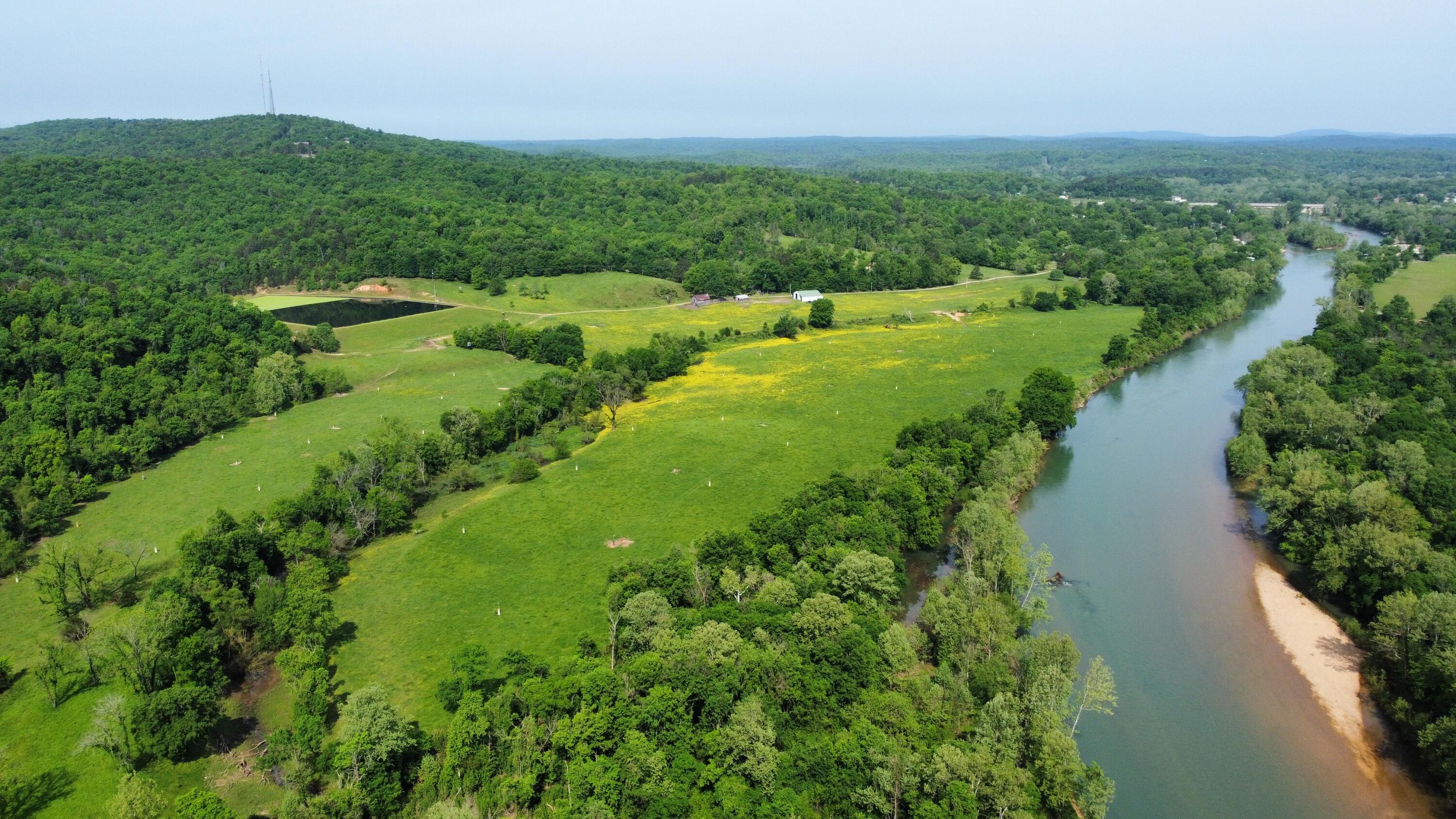 Here's your chance to own one of the few River Farms that still exist on the upper Current River.  123 Acres with over half of a mile of river frontage. This Unique Property borders the Ozark National Scenic Riverways, and Federal Park.  That area is a wildlife refuge that hasn't allowed hunting in over 70 years. The deer hunting on this farm is as good as it gets in Southern Missouri.  The owner of this property and a few select people that have been allowed to hunt there have seen and harvested some of the biggest whitetail known to this area. It is currently outfitted with two redneck blinds that go with the property.  These two blinds are in locations near the refuge boundary where deer pour out of the timber to these lush green bottom fields in the evenings.  Don't miss your chance to own a legendary Whitetail haven on one of the most beautiful river systems on the planet.