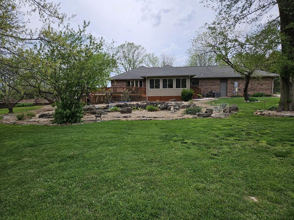 All-Brick Walkout Basement Home on 3.2 Acres. This captivating all-brick walkout basement residence features 4 bedrooms, 3 bathrooms, and 3,872 sq ft of living space on 3.2 acres. This includes a 36x60 shop building with a 4-car garage, concrete floor with drains, 220 amp wiring, 8x10 plant room, and a carport. Additional amenities include a storage shed with electricity and a outbuilding with water and electricity. The main floor offers a large living room with a gas fireplace, hardwood flooring, and sliding doors to the main deck overlooking the Olympic-sized in-ground swimming pool. The gourmet kitchen features granite counter tops and new sinks, tile flooring, a kitchen island with an additional sink, a kitchen bar, a large pantry, and an adjacent dining room. Updates include a new cooktop in 2024 and a Bosch dishwasher added in 2018. A 12x20 heated and cooled sun porch off the kitchen The main floor also includes a primary bedroom with an en-suite bathroom, two additional bedrooms with hardwood flooring, and another bathroom. The basement has a second primary bedroom with a large bathroom, walk-in shower, jetted tub, and a gas fireplace. There is also a 5th nonconforming room with a sauna, plus a large living space with luxury vinyl plank flooring throughout and tile in the bathroom and utility/furnace/storage room. This home has numerous updates: the heat pump and AC were replaced in 2014, the septic tank was pumped in March 2024; pool liner, filter, & light were replaced in 2019; sand was replaced in 2023; new motor in 2022; and the booster pump in 2015. The upstairs patio doors in the living room and main primary bedroom, featuring internal blinds, were added. The upstairs patio doors in the living room and main primary bedroom, featuring internal blinds, were added in 2022, and the downstairs living room patio door was replaced in 2014Outdoor amenities include an Olympic-sized in-ground swimming pool, a large Koi and goldfish pond, and mature landscaping.