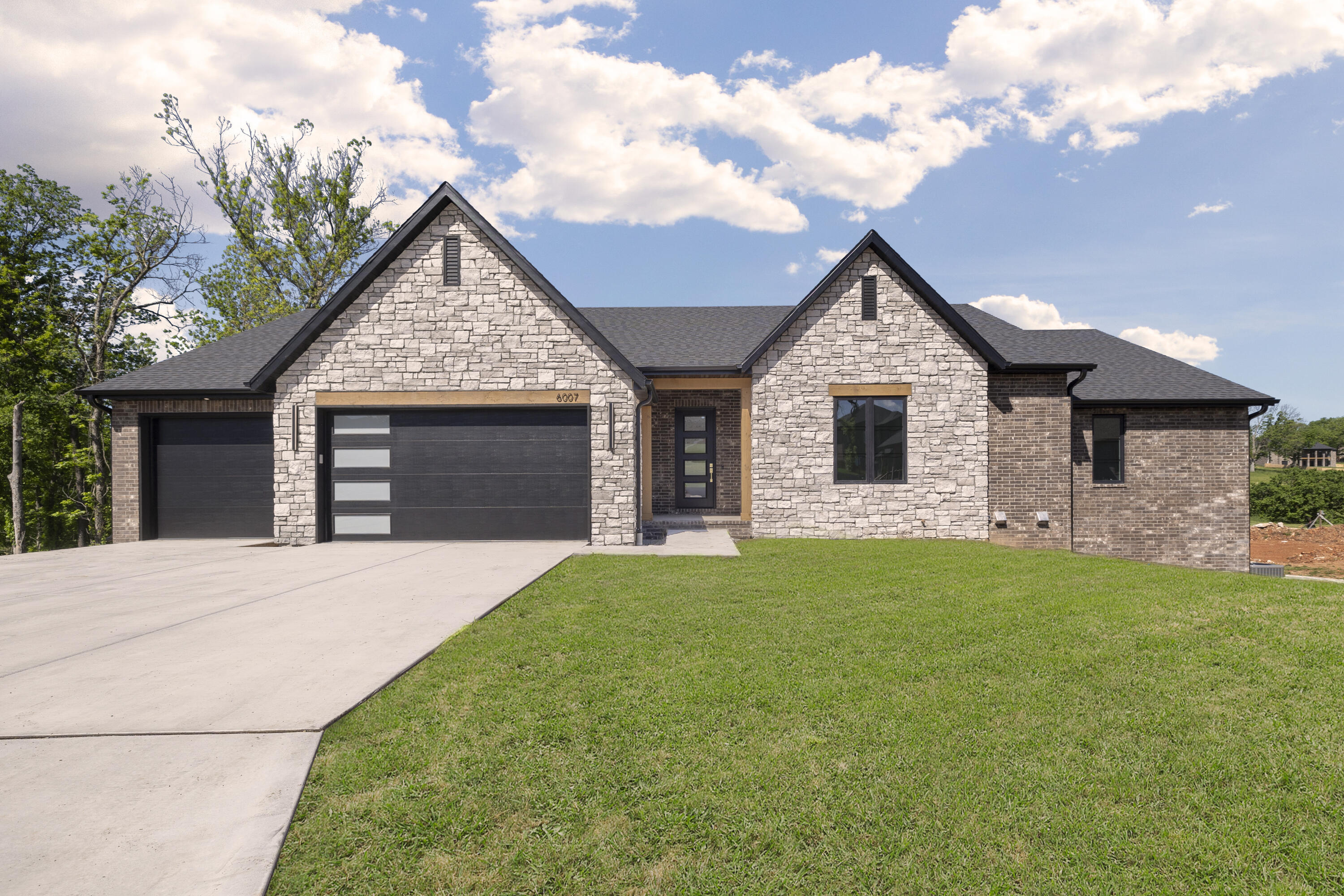 This impressive home was just completed! Some of the high end features include wood floors throughout the main level (except spare bedrooms), raised ceilings, a split bedroom floor plan (with 3 bedrooms on the main level), 3 1/2 baths, spacious screened deck and beautiful views from the many windows. The basement offers a huge living area, wet bar, media room/game room and two more bedrooms.
