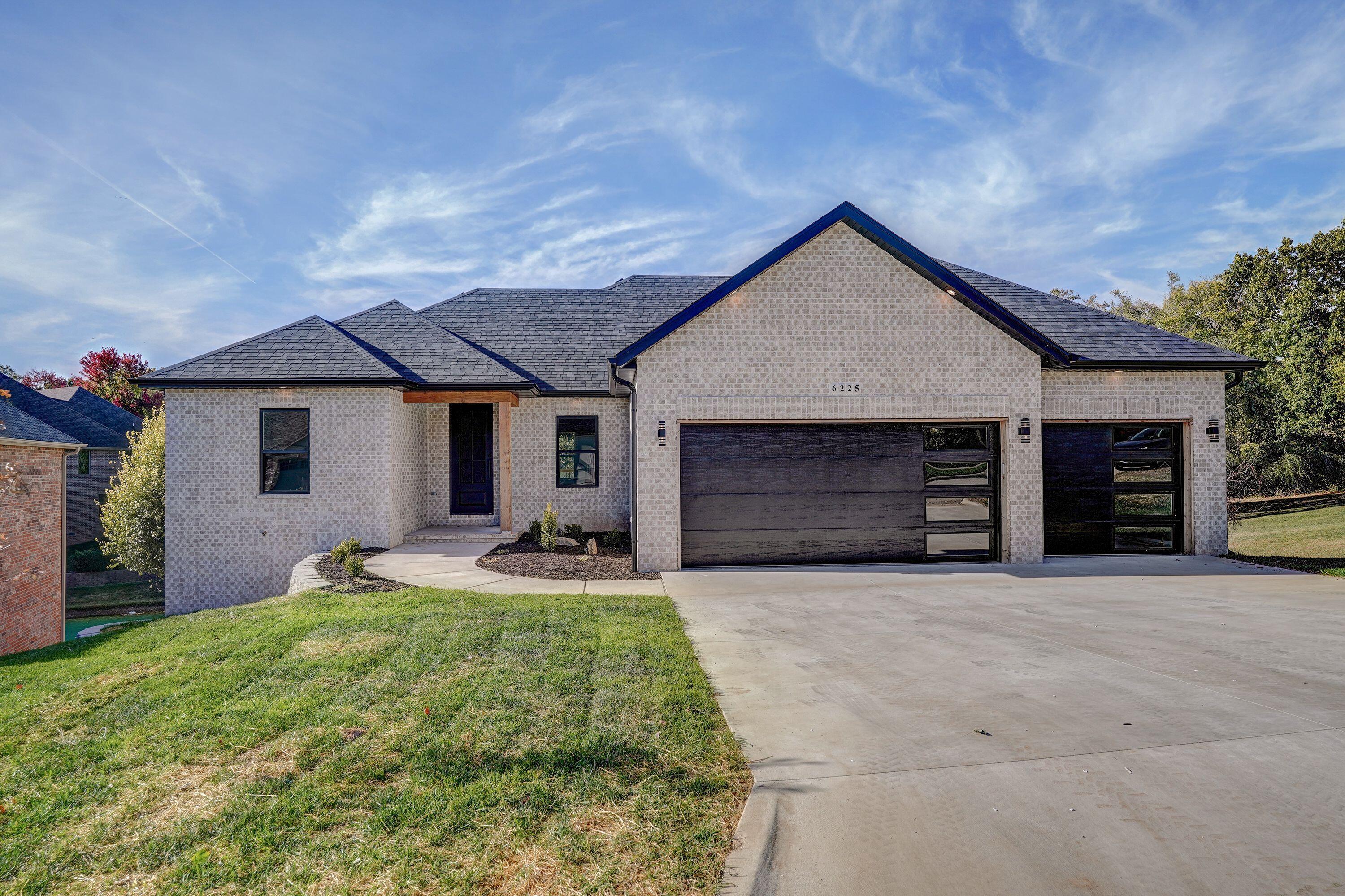Stunning All Brick, new built home located in the hidden gem of Granite Springs Subdivision, minutes from Evans Road and 65 with its own private lake! Home is in the Field/Glendale School district of Springfield with an Ozark address. This walkout basement home boasts a very modern feel from the custom 8-foot black iron door that opens into the living room with hardwood floors, natural lighting, touches of black and brass pops of color from the fixtures.  Home offers 6 bedrooms, 3 baths, 2 laundry rooms, and quartz and granite counters throughout. The kitchen is a chef's dream featuring a pot filler faucet,  gas stove/oven, plus an electric wall oven. The large walk-in pantry is set up for ALL your storing needs including space for a coffee bar. Kitchen offers an abundance of cabinetry, counter space for prepping as well as an eat in island and dining area.The Master bedroom has tray ceilings, wood floors, a large master bath with a walk-in cultured marble, dual head shower. Other features include granite counters, dual sinks, a soaker tub, tile flooring and a large walk-in closet. The laundry room and mudroom are located just off the garage. Two other bedrooms and bathroom complete the main level.  The completely finished basement features a large family room with a kitchenette, sink, dishwasher, hookup for refrigerator and granite island.  Just off the family room you will find a media room ready for all those family movie nights! In addition, there are 3 nice sized bedrooms, a tub/shower bathroom with dual sinks, and the second laundry room.Enjoy those peaceful evenings on the top or lower covered deck with stunning views of the subdivision lake as well as the wildlife that roams in the field nearby. The backyard has plenty of room for a play place or space to put in a pool.  Call today to see this gorgeous home!