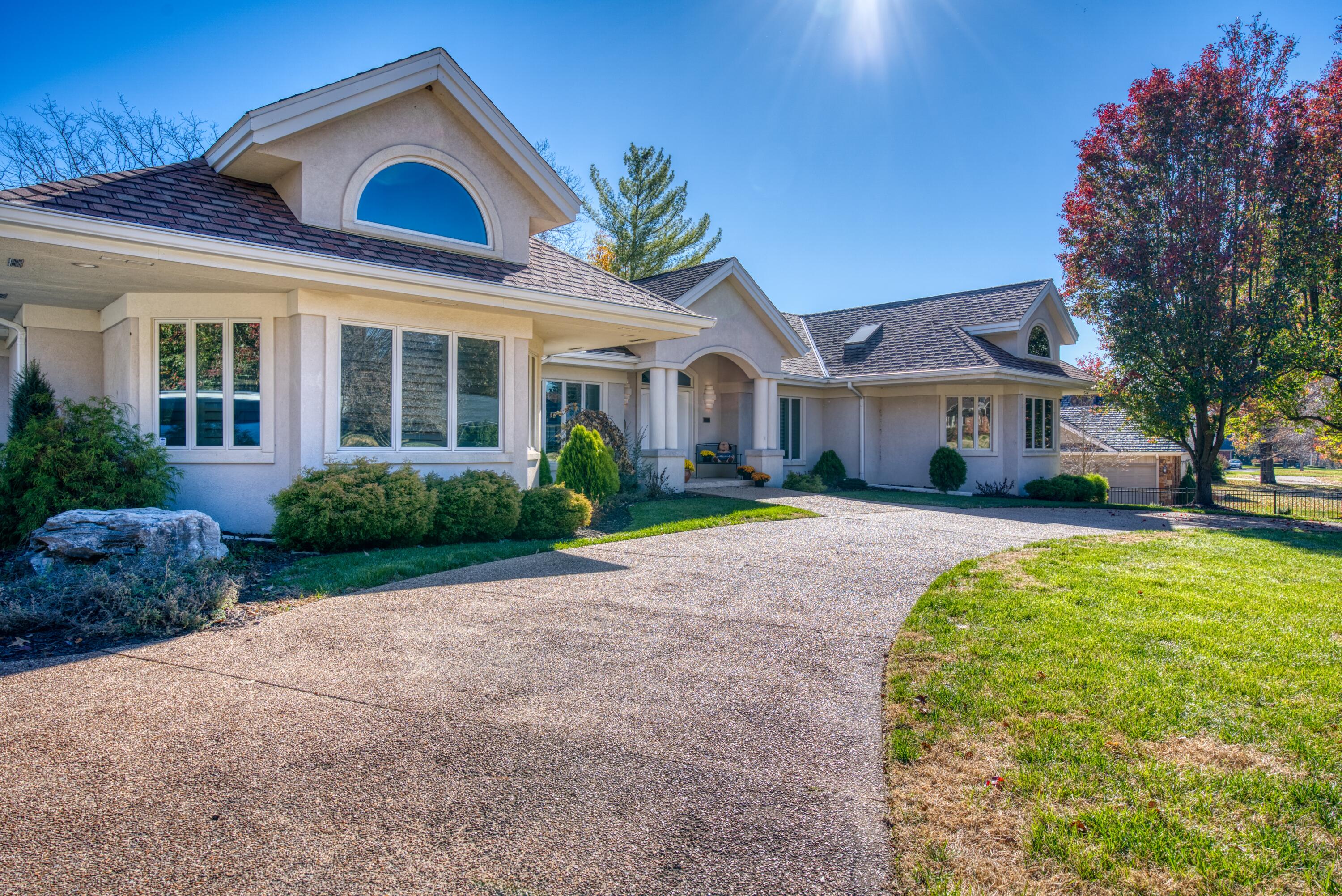 You will fall in love with this gorgeous one level luxury home, fully renovated in 2020 and situated right on the lake in the classic Springfield neighborhood of Southern Hills. Inside the dramatic double front doors is a wide foyer with a statement chandelier and views straight through the living area and out to the lake. The living room is spacious, with high ceilings, a wall of windows, plush new carpeting and a custom gas fireplace. The formal dining room is a wonderful entertaining space with a wet bar, sparkling chandelier and space for a large table. The kitchen is a dream with a large island, beautiful, rich countertops and wood cabinetry and a striking tile backsplash. In addition to the gas range, there is a second oven, as well as a built-in microwave and refrigerator, all Kitchenaid. There is also room for an additional dining or lounge space, with peaked ceilings, skylights, and again overlooking that beautiful lake. On this wing of the house you will also find a powder bath, large laundry room with walls of storage, access to the basement, and a large bedroom with dramatic peaked ceilings and an en suite bath. The primary bedroom on the other side of the home is huge, with its own wall of windows looking onto the lake and a truly luxurious bathroom with jacuzzi tub, large walk-in shower, double vanities, two walk-in closets, and vaulted ceilings. The third bedroom has a wall of built-in bookcases and is currently being used as an office. The large back deck, new in 2022, offers multiple seating and dining spaces and can be accessed from several places in the house. Steps down to the backyard lead to a fire pit and the lake. The entire front yard is fenced, with a gated entry into the circle drive and to the garage. This home has been so tastefully updated and meticulously maintained and cared for. It is a gem in one of the most desired neighborhoods in town--you just have to see it for yourself!
