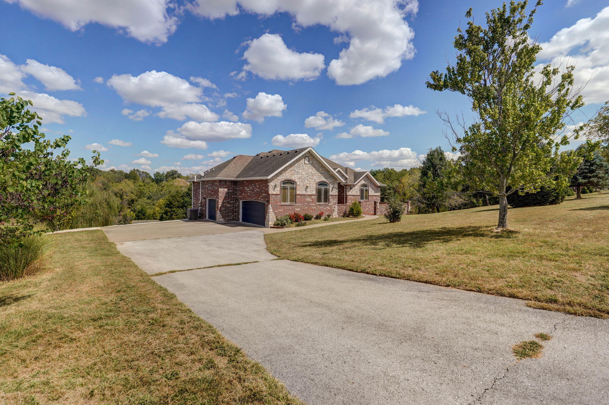 Stunning, all-brick, 4bdrm home with a walkout basement in Ozark with NO HOA! The home is situated on 3 acres and has picturesque views and plenty of mature trees. As you walk in, you will appreciate the semi-open concept, the hardwood floors that run across the main living area, and the overall coziness of the home. The kitchen is spacious with granite counters, lots of storage space, and a walk-in pantry. The large master ensuite has dual sinks, a walk-in shower, jetted tub, and a huge walk-in closet. The main floor also features one additional bed/bath, and a laundry room that has all the cabinet space you need! The basement has a second living area with fireplace, wet bar, and two more bedrooms. Additionally, there is a John Deere/storage room that is heated/cooled and can easily be converted to a gym--or even another bonus room/play room for the kids! There is a 16x14 screened balcony that overlooks the yard and has impeccable views to the pond--a perfect place to enjoy that morning cup of coffee! Additionally, there is a gazebo which has electricity and a fan--the perfect spot to entertain or relax in the evenings. Lastly, there is a detached garage/workshop (23 x 11.3) that can store all your tools or serve as an extra parking spot for your boat or RV. Minutes to coveted Ozark schools, and just a short drive to Springfield, shopping centers, parks, etc. Call for a showing today!