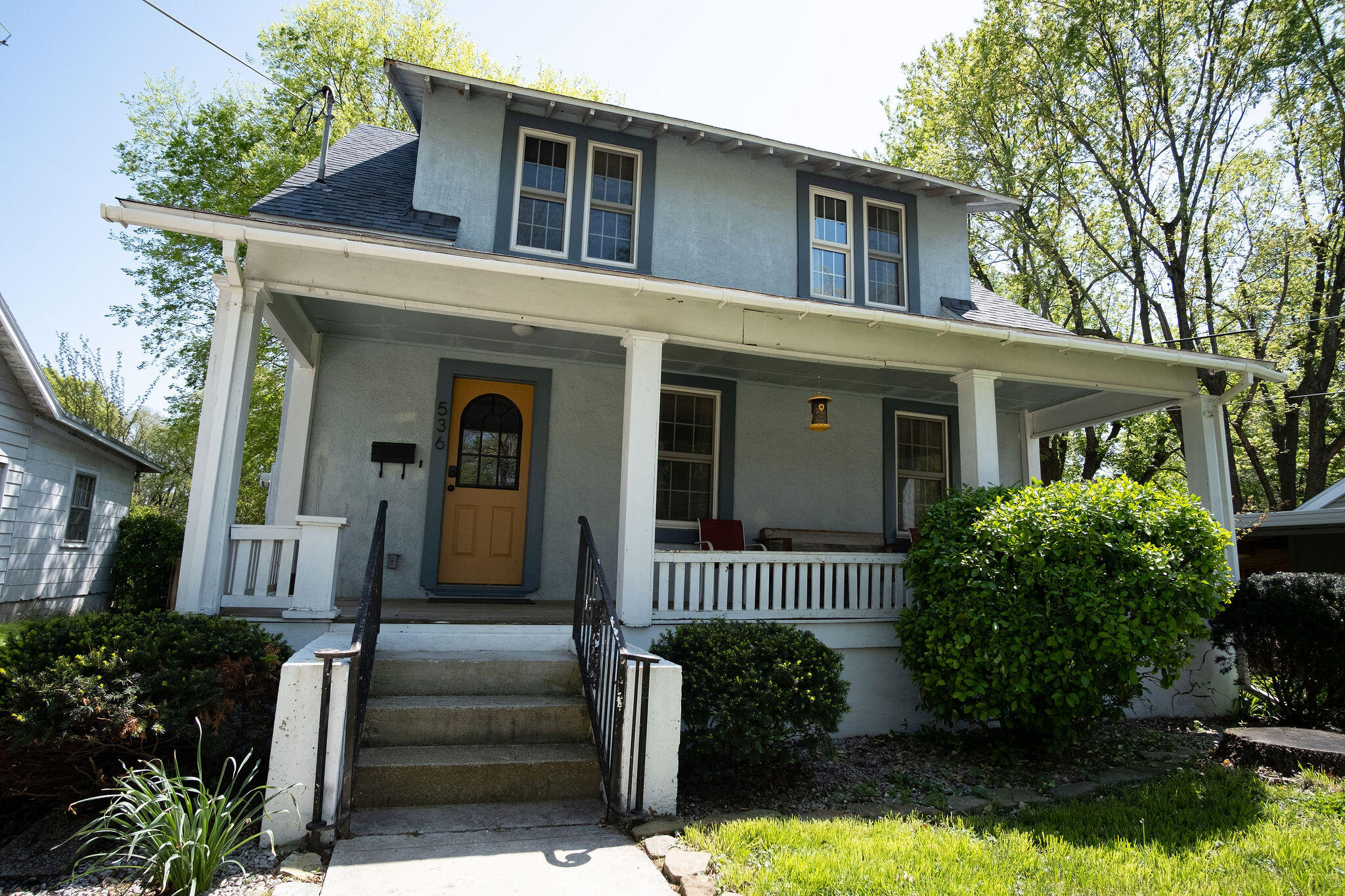 Don't miss out on this beautiful 1940's Craftsman Bungalow in a fantastic location with so many details that add to its charm. Mature landscaping accents the large covered patio--a classic bungalow feature--with large  craftsman-style columns. Step inside the entryway with stairs leading the second floor, a half bath conveniently placed in the hallway, and the entry to the living room located to the right. The beautiful original hardwood floors stretch throughout the living room and continue into the open arched entryway leading to the brightly lit formal dining room set below french doors. The french doors filter in an abundance of natural light and open up to the large deck overlooking a fenced-in backyard. You'll find the kitchen located adjacent to the formal dining room with tiled flooring and floating shelves that add to the character and charm of the house. In the kitchen is a door that leads into a lovely mudroom framed with windows and set below two skylights. This brightly lit room has a washer and dryer hookup, floating shelves, and a door that leads directly out into the backyard. You'll also find the steps leading down to a large basement with potential to be finished. Return to the entryway and take the stairs to the second floor. In the hallway is a full bathroom, the first and second bedrooms, and the master bedroom nestled at the end of the hallway with large windows and a walk-in closet. This home has a matching detached garage and a lovely backyard with mature trees and subtle landscaping. Located near Bass Pro Shop's Wonders of Wildlife Museum and Aquarium, Starbucks, and several restaurants as well as quick access to downtown, you'll enjoy many conveniences. This home has so much potential, so don't miss out on the opportunity to make it yours by scheduling your showing today!